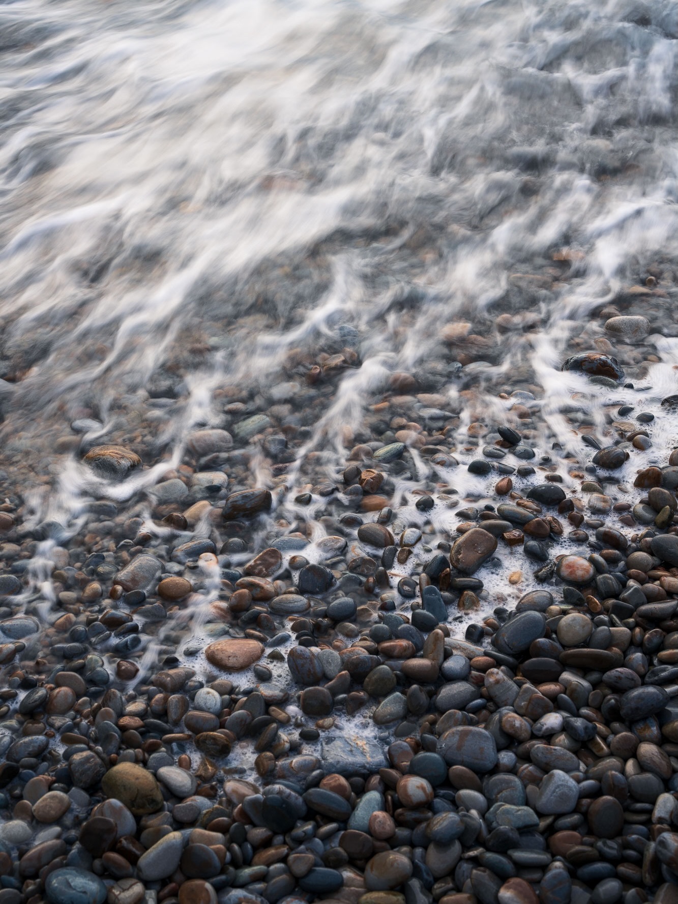 Enjoy the little things.
While many of my images from Asturias show the raw and dramatic character of this coastline,
these photographs move in a slightly different direction. There is no grand scene and no striking light here,
just small details along the shore that are easy to overlook at first. Water moving gently over stones,lines forming in the sand, textures shaped slowly by time and tide.
But the longer I stayed and the more attention I gave, the more depth and beauty started to reveal themselves. Sometimes photography isn’t about searching for something more, but about learning to truly notice what is already there.