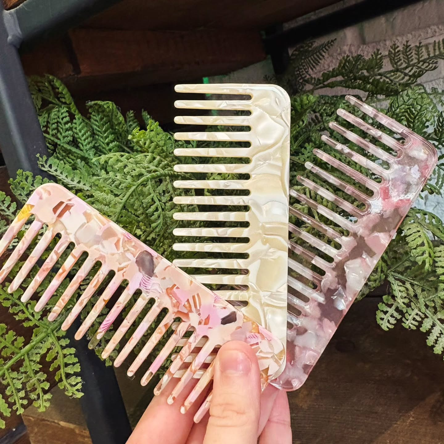 P L A N T // C O M B S
You may have spotted these little gems in our retail area…
Our plant based combs are made from cellulose acetate — a plant-based material used in premium hair tools 🌿(aka not your standard plastic)
Why that matters:
- Smoother than plastic, meaning no snagging, and less static charge
– More hygienic than wood as it won’t absorb oils or products (easy to clean).
– Gentler than metal, meaning no harsh dragging on the hair shaft
– Stronger + more flexible, so no snapping in two mid-style!
This results in less frizz, better definition in your style, and healthier looking hair!
Our go-to uses for this comb are:
– Dressing out heat curls once cooled for a soft, luxe finish
– Distributing product evenly throughout natural curls + waves!
This is how these plant based combs compare to other materials:
Plastic: Is cheaper, but can be rougher + create static
Wood: Is more porous, so in turn can absorb product/oils and become less hygienic over time
Metal: Is very firm, which can feel harsh and also drag on the hair shaft (damaging).
These combs are a steal at £6 each, and come in a range of colourways 😍
They’ve been flying out, so be quick to grab yours!
#PlantBasedComb #DressingOutComb #Northwich #CheshireHairSalon #SustainableHairTools