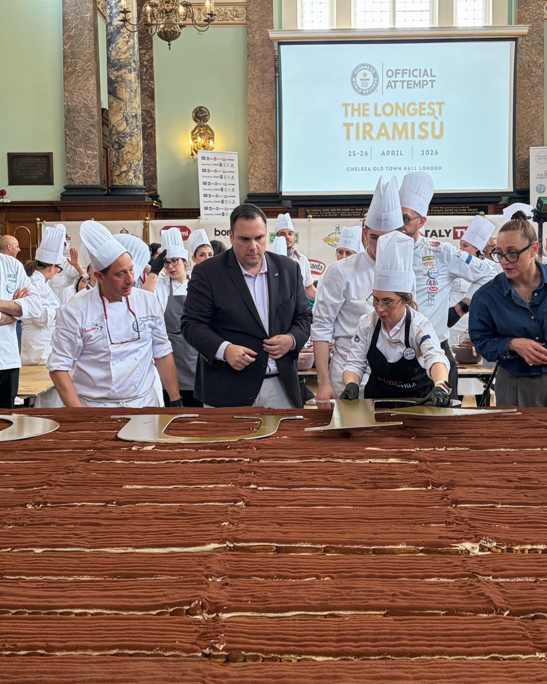A new world record was set today for @thelongest_tiramisu
The @guinnessworldrecords was broken with the most famous Italian dessert reaching a length of 440.6 m (1,445ft) - beating the previous record of 273.5m (897ft) set in Milan in 2019.
Our member @mirkoricci @complitaly_tv led a team of over 100 chefs who assembled bricks of #tiramisu at #chelseaoldtownhall using extraordinary amounts of ingredients:
99kg of coffee,
465kg of sugar,
1843kg of mascarpone,
152,000 savoiardi biscuits, or ladyfingers,
60kg of cocoa
348kg eggs
The judges measured the tiramisu with meticulous precision at different stages of the construction that took place live on site -in accordance with the rules.
The tiramisu feat was dedicated to the King and the royal family and supports the charity @eShareLife.
One year in the making the record was celebrated by a jubilant crowd.