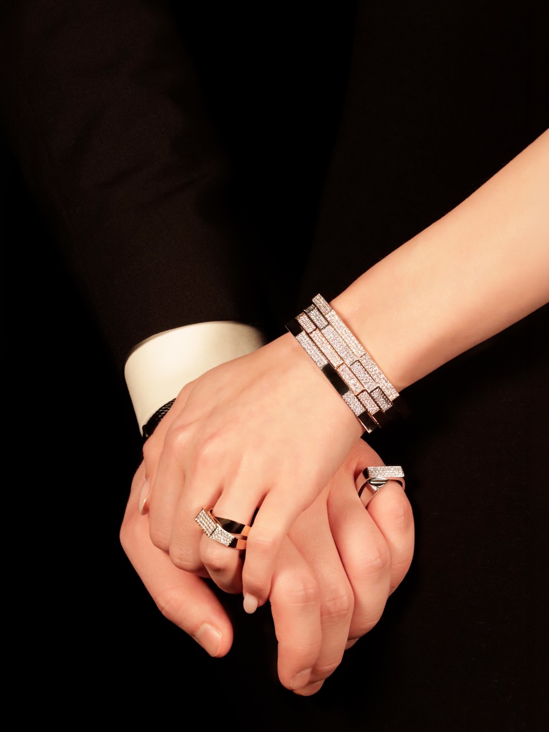 452 diamonds between two hands. Only one detail that connects them.
The crossover. Two bands meeting at a single point, one set with diamonds, one left clean and polished. It is the same design on both rings, the same structure, the same intersection, the same intention. His in 18-carat white gold, 40 brilliant-cut diamonds in F-VS at 0.35 carats, 11.1 grams. Hers in 18-carat rose gold, 78 brilliant-cut diamonds in F-VS at 0.68 carats, 12.4 grams. Different metals. Different stone counts. The same cross at the centre of both.
At her wrist, four bangles worn as one. A yellow gold bangle set with 135 brilliant-cut diamonds at 1.50 carats. A rose gold bangle carrying 133 diamonds at 1.33 carats. Two white gold bangles, each set with 83 brilliant-cut diamonds in F-VS at 0.92 carats. Three metals, four pieces, 4.67 carats of diamonds stacked across 64.6 grams of gold.
452 diamonds in total. Two rings designed to find each other.
By private appointment only.
The BrandZ — A Luxury Experience.
#thebrandz #couplegoals