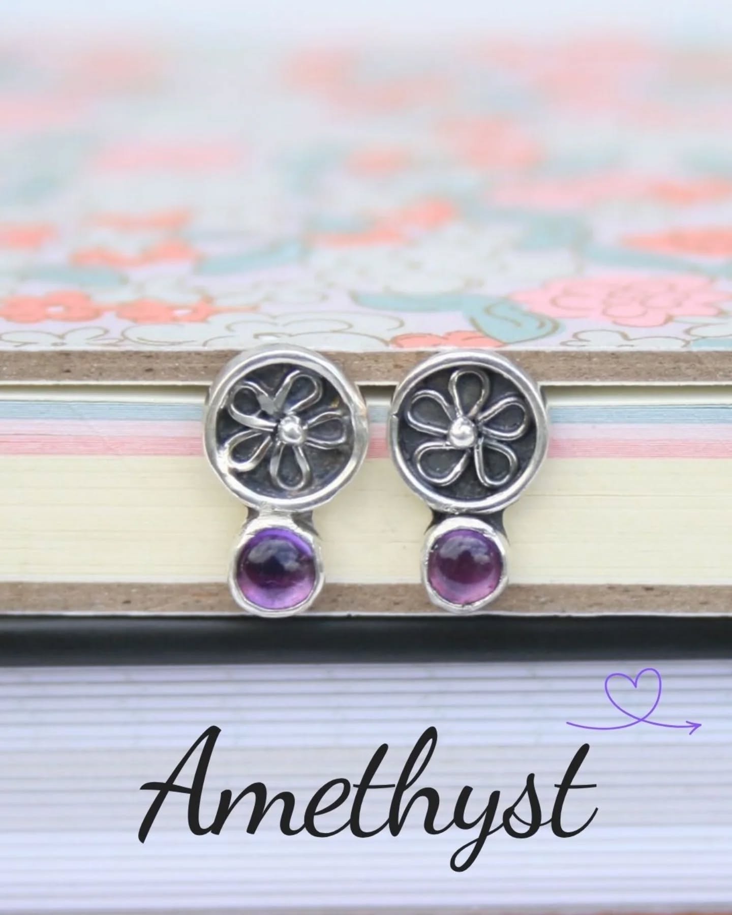 A few weeks ago I shared a photo of a single earring after I managed to lose its partner down the sink while rinsing it - right at the point they were ready for stone setting, which was more than a little frustrating!
Iāve now remade the missing piece and the stones are safely set. Theyāre such a dainty pair, measuring just 13 mm in length, and I love the little shadowbox detail with the silver flower sitting just beneath the amethysts.
Theyāre now available, so if youāre interested or have any questions, feel free to get in touch š