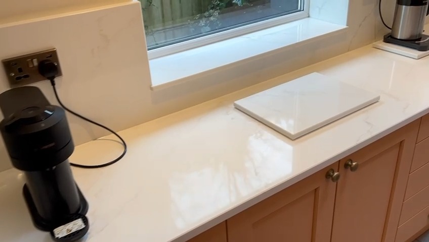 Golden Thunder worktops fitted on salmon pink kitchen with recessed drainer, splashbacks and window sill #homeimprovement #worktopscheshire #kitchenideas #kitchenworktops #quartzworktop #quartzworktops