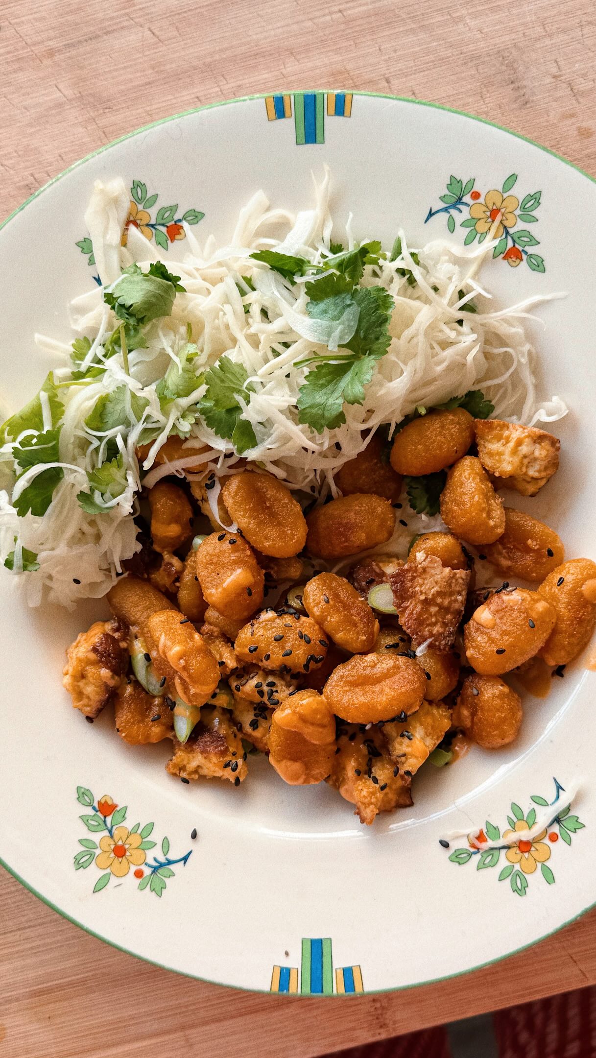 Warm Gnocchi Salads - Episode Two.
Gochujang Cauliflower Gnocchi and Tofu Salad with @alldressedupdressings 🫚
This Pumpkin Gnocchi salad from @izziemcox is punchy and packed with flavour. All Dressed Up’s brand new Gochujang Ginger Dressing brings a quiet heat which ties the flavours together and proves that the right dressing really does change everything.
Serves 2
200g smoked tofu, crumbled into large pieces
250g Sunny & Luna Pumpkin Gnocchi
1 tbsp rapeseed oil
½ Chinese or white cabbage, finely shredded
1 tsp sesame oil
1 lime, juice only
10g coriander, leaves picked
1 green chilli, finely sliced
4 tbsp All Dressed Up Gochujang Ginger Dressing
sea salt and freshly ground black pepper
1 spring onion, finely sliced, to serve
1 tbsp black sesame seeds, to serve
Preheat the oven to 180C Fan. Line a large tray with baking paper and add the tofu pieces, gnocchi, oil and plenty of seasoning and toss together. Roast in the oven for 20 minutes until golden and crisp.
Meanwhile, add the cabbage to a medium bowl with the sesame oil, lime juice and some salt and scrunch together.
After 5 minutes, mix through the coriander and green chilli.
Once cooked, transfer the gnocchi and tofu to a large bowl and toss with the dressing.
Divide the gnocchi between two bowls, top with the spring onion and sesame seeds and serve the slaw alongside.
Enjoy!