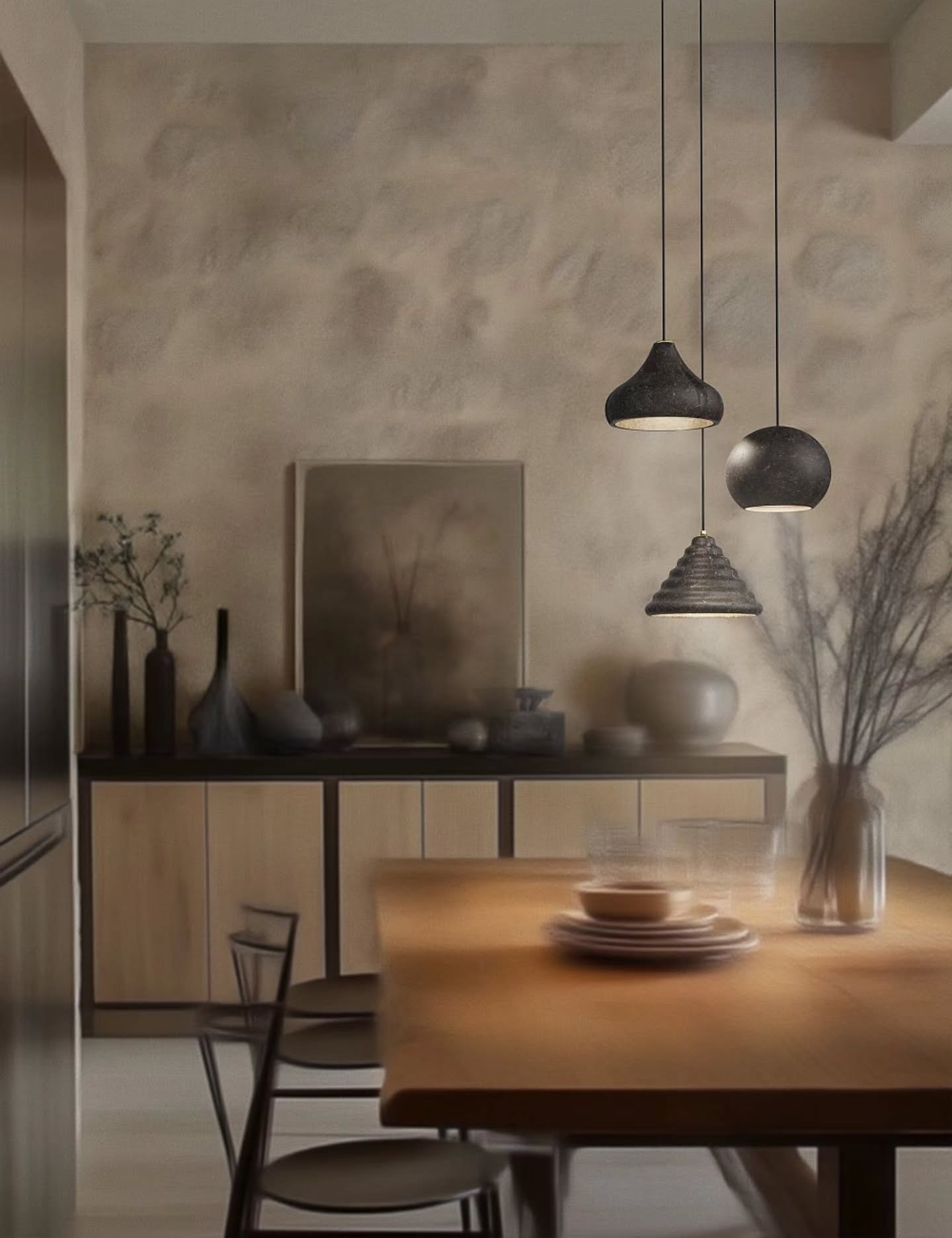 The #Eolie collection by @foscarinilamps is a poetic tribute to the volcanic soul of the Italian Lipari Islands, echoing the primal spirit of Alicudi, Filicudi, and Panarea. These pendant lamps bring the raw elegance of recycled lava stone into the interior through an innovative and eco-friendly manufacturing process. Unlike marble, lava requires no mining; instead, volcanic stone remnants are collected from the earth’s surface and blended with resin to create a lightweight, malleable, and sustainable material. The varying grain size of the recycled matter creates unique porosities and "craters" on the surface, making every lamp a one-of-a-kind masterpiece with an unrepeatable texture. The three distinct organic shapes emphasize natural imperfection and engage in a subtle dialogue with the space without overwhelming it. The minimalist design is completed with a black cable and a galvanized metal canopy, providing high-quality 20W LED light and the possibility to create enchanting compositions with multiple fixtures. Design: Alberto + Francesco Meda. #hektorlight #LightingDesign #InteriorDesign #ItalianLighting
