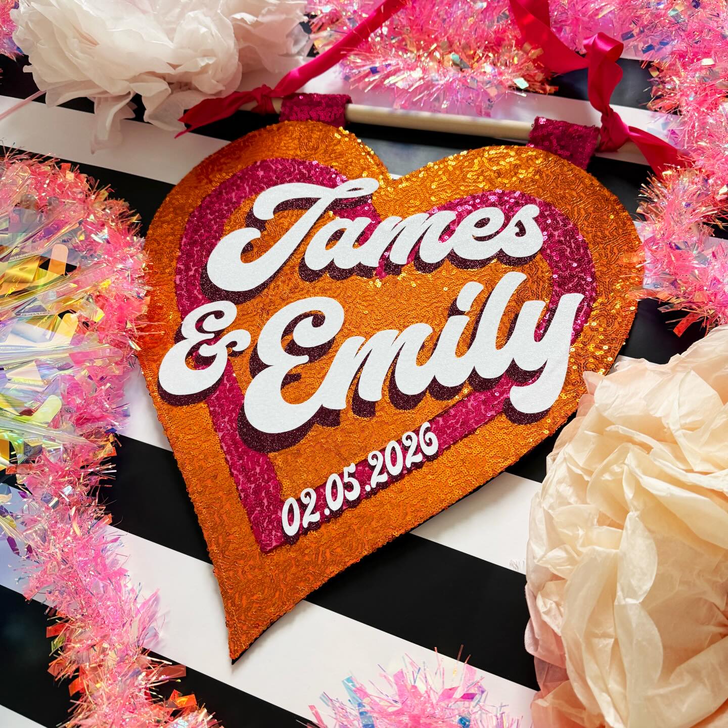 When Emily contacted me back in March and ordered her sequin wall hanging, we found the most amazing fuchsia and orange sequin coloured fabrics to complement her colour scheme - I mean, orange and pink - how delicious! An absolute fave colour combo of mine so this was so nice to make and it was really exciting to use different colours.
I’m keeping my fingers crossed that the weather is kind to them today and that Emily might share some pictures of her day in the future so I can see this amazing colour scheme! This biggest question I have is I wonder what colour her dress will be?
To be a fly on the wall !!! Have an absolutely amazing day and congratulations!! 🥂
#WeddingInspo #WeddingDecor #prop #HandmadeWallArt #textileartist |handmade sequin wedding decor |wedding day | orange and pink | bride and groom | 2026 bride |maximalist wedding |wedding signage |wedding favours