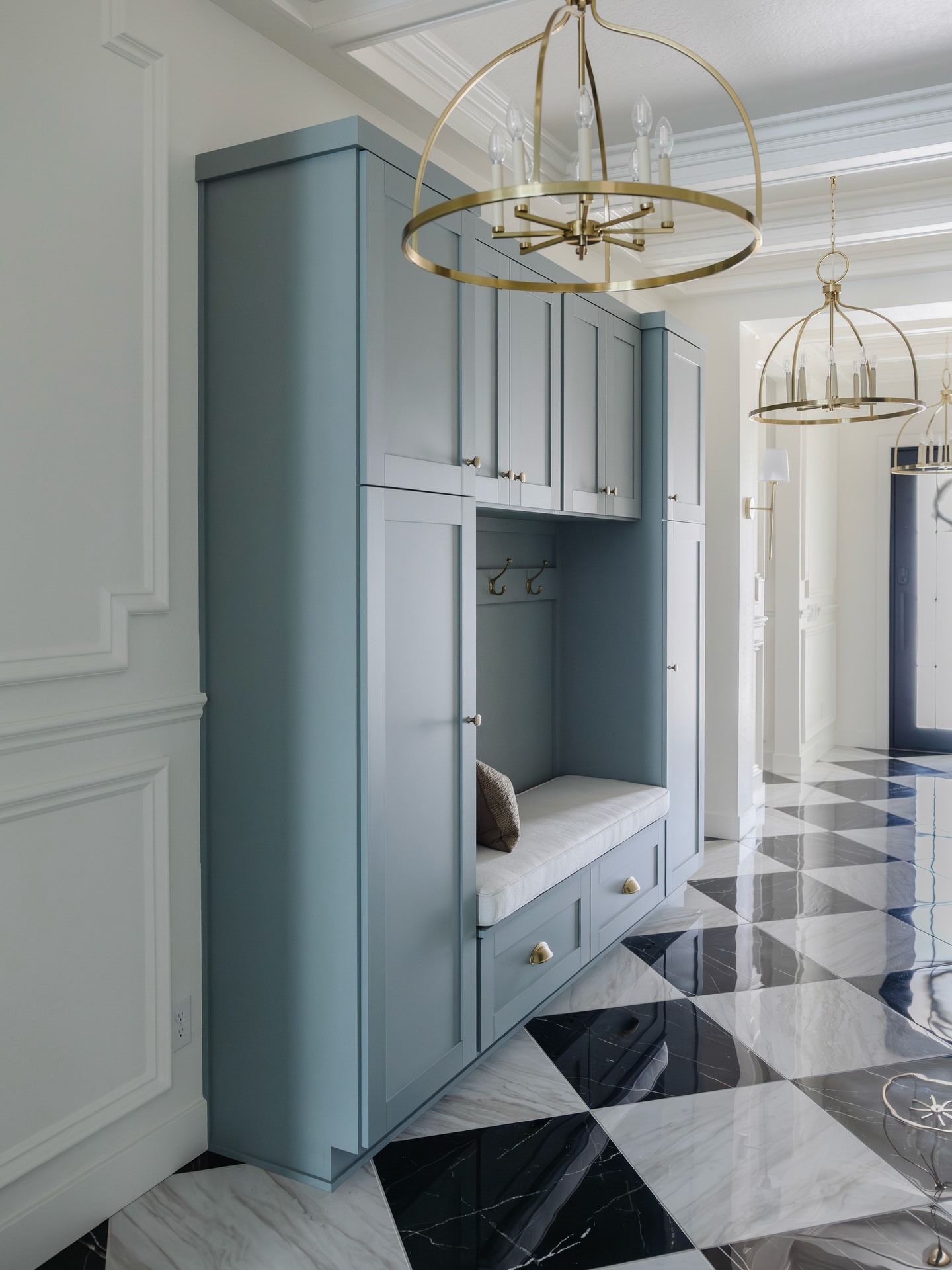 Entryway goals, but make it functional.
This space proves that the first impression of your home doesn’t have to be wasted space.
Custom storage, a built-in bench, statement lighting, beautiful millwork, and that checkered marble floor… every detail works hard while still feeling polished and timeless.
Comment DESIGN if you want help creating a home that feels this intentional.