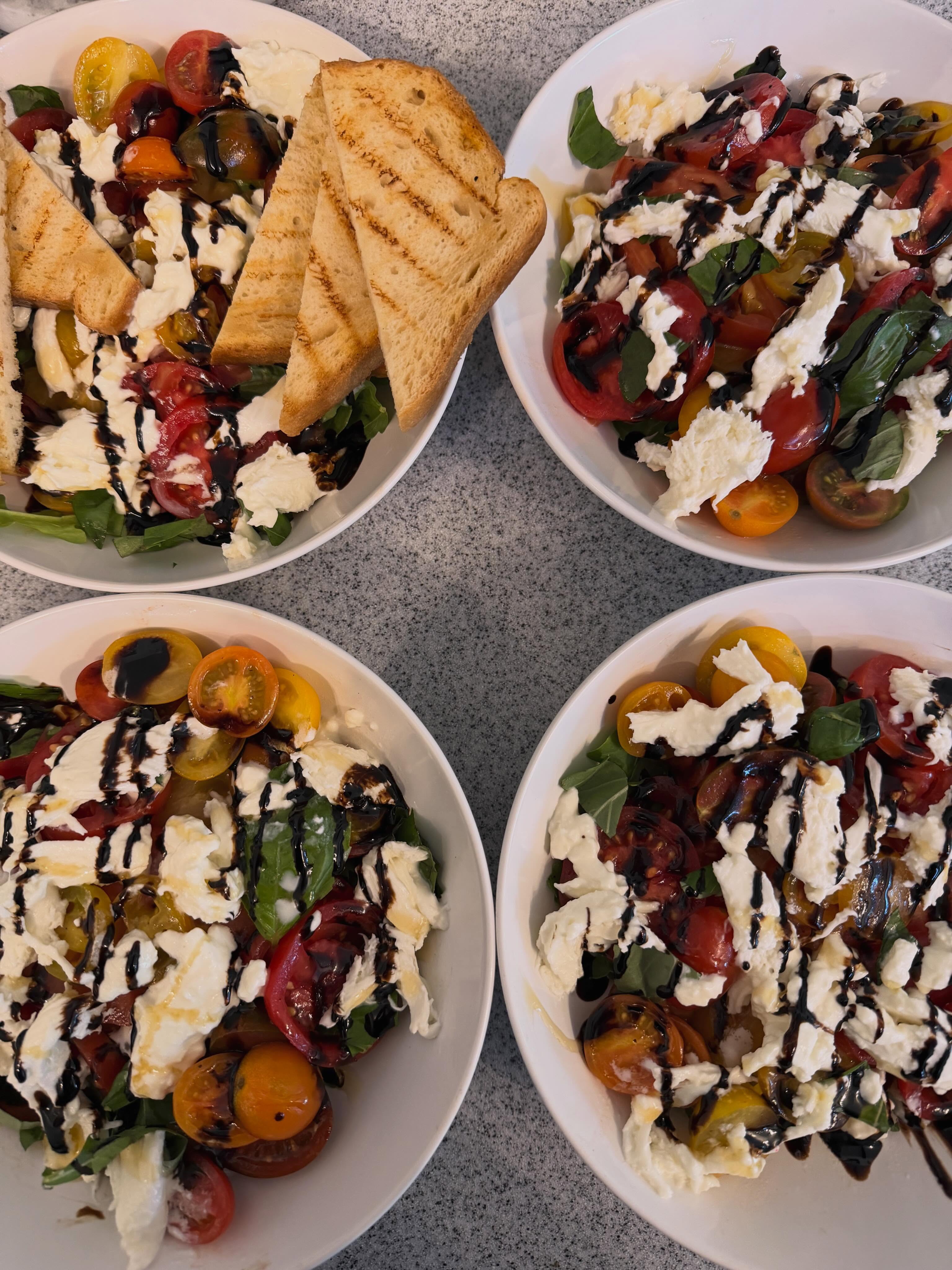 Tomato & burrata salad, beef medallions with chimichurri, roasted root vegetables, truffled mashed potatoes, and a berry cobbler with vanilla ice cream.