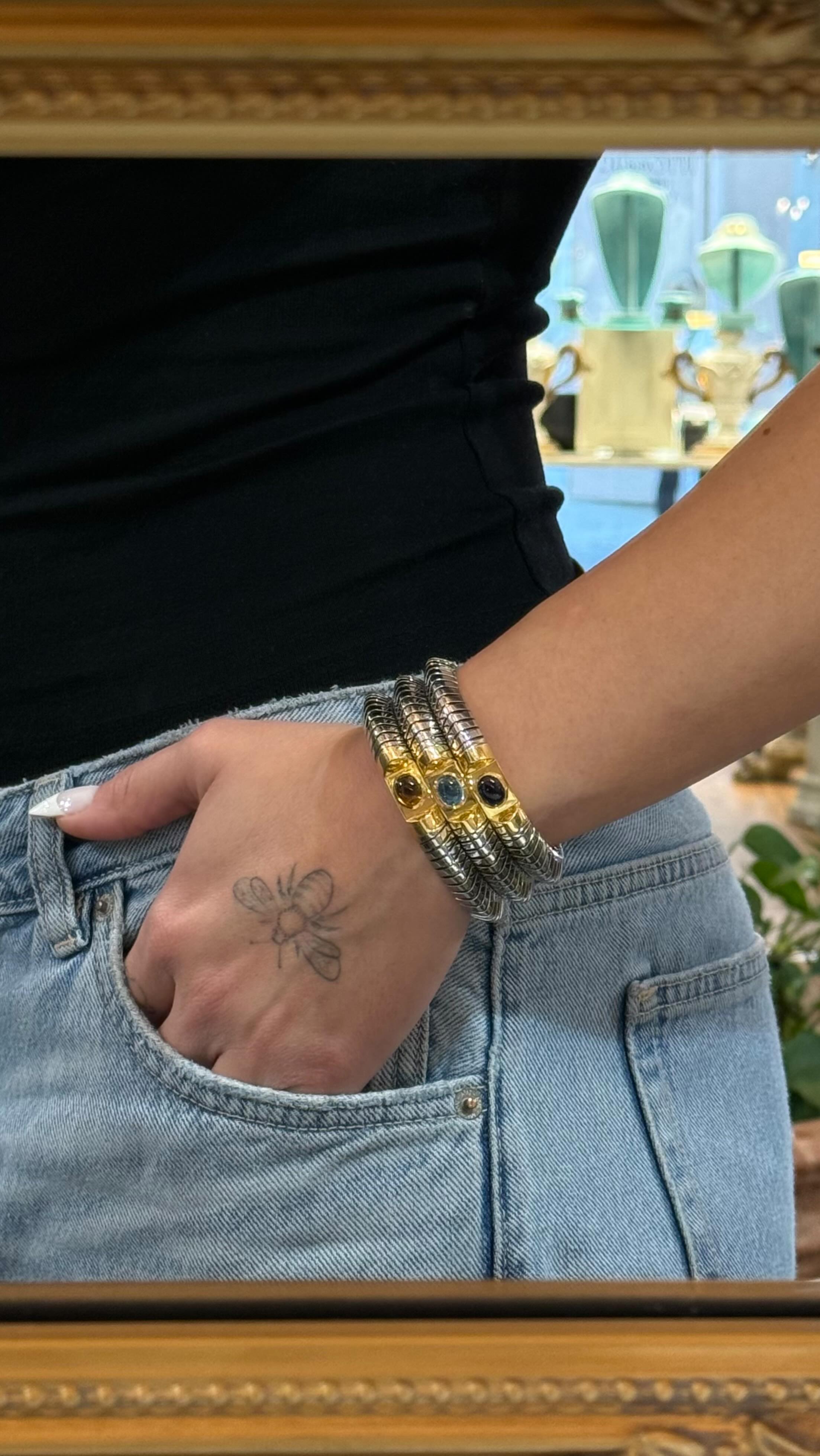The iconic @bvlgari Tubogas bracelet.
Each polished steel band is adorned with an 18-karat gold element, embellished with cabochon stones: yellow and deep blue topaz, and amethyst.
A statement piece, perfect for both special occasions and for adding a touch of iconic luxury to an everyday look.
