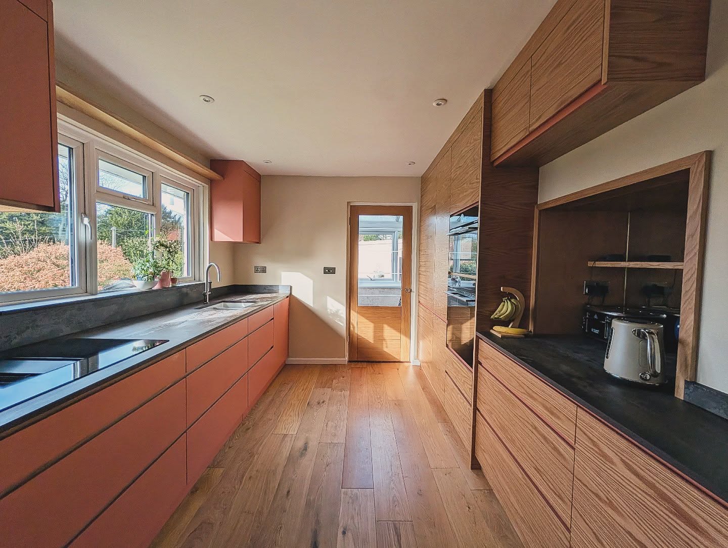 A snapshot of a recent kitchen by the incredible Inwood Design team.
Oak veneered cabinetry with handless doors, one side painted Farrow & Ball Red earth with oak details and one side Oak veneered doors with painted details. Topped off with Dekton work surfaces top of the range appliances and LED lighting from Sensio.
All designed, manufacturer and installed by the talented teal at Inwood Design.
#kitchendesign #bespokecabinetry #fittedfurniture #handmade #asuniqueasyou