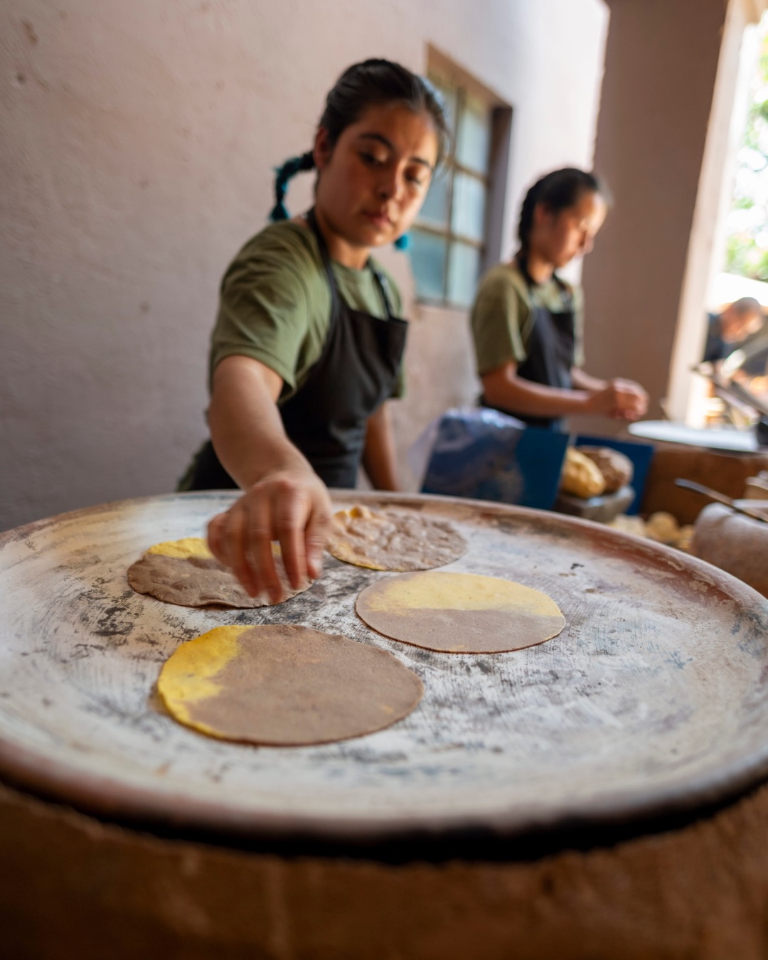 La cocina en Oaxaca es muy especial, lleva de colores, sabores.
El sonido del comal caliente, el olor de la tortilla recién hecha, las manos que llevan años y generaciones, perfeccionando cada receta, todo tiene una historia.
Aquí la cocina tradicional no es algo que se conserva, es algo que sigue latiendo todos los días.
Cada ingrediente, cada técnica, cada detalle… viene de un lugar muy profundo.
Y cuando te sientas a comer, lo entiendes: no es solo comida, es cultura, es raíz, es hogar.
Por eso, más que llevarte sabores, te llevas recuerdos que se quedan contigo
