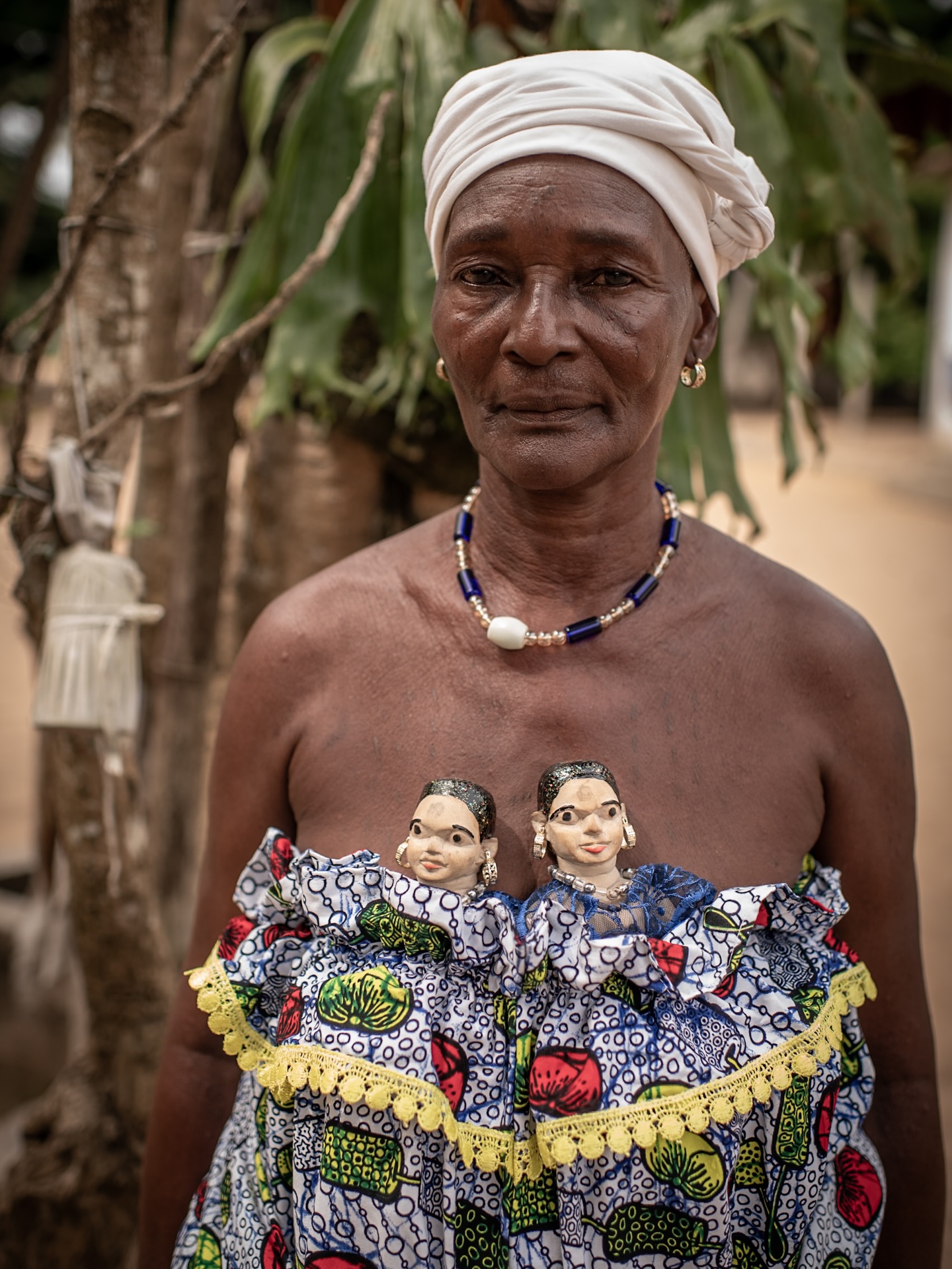 There is another aspect of Mother’s Day one has to consider while celebrating motherhood in this loud and joyful manner that comes from every corner of IG for the last couple of days. Mémé here holds a high position in her Vodun community. All of her pregnancies have been multiple: she carried twins and triplets, a phenomenon more frequent in parts of Benin than in many other regions. Many of these pregnancies did not result in live birth, and surviving newborns often died soon after. In her tradition, carved wooden figurines are sometimes given to mothers to help them cope with the trauma of loss, allowing them to carry and care for a tangible presence of the children they lost. Mémé is respected both for her status and for the grief she has endured: of the 21 children she gave birth to, only one son has survived into adulthood.
#womenphotographers #photoreportage #socialphotography