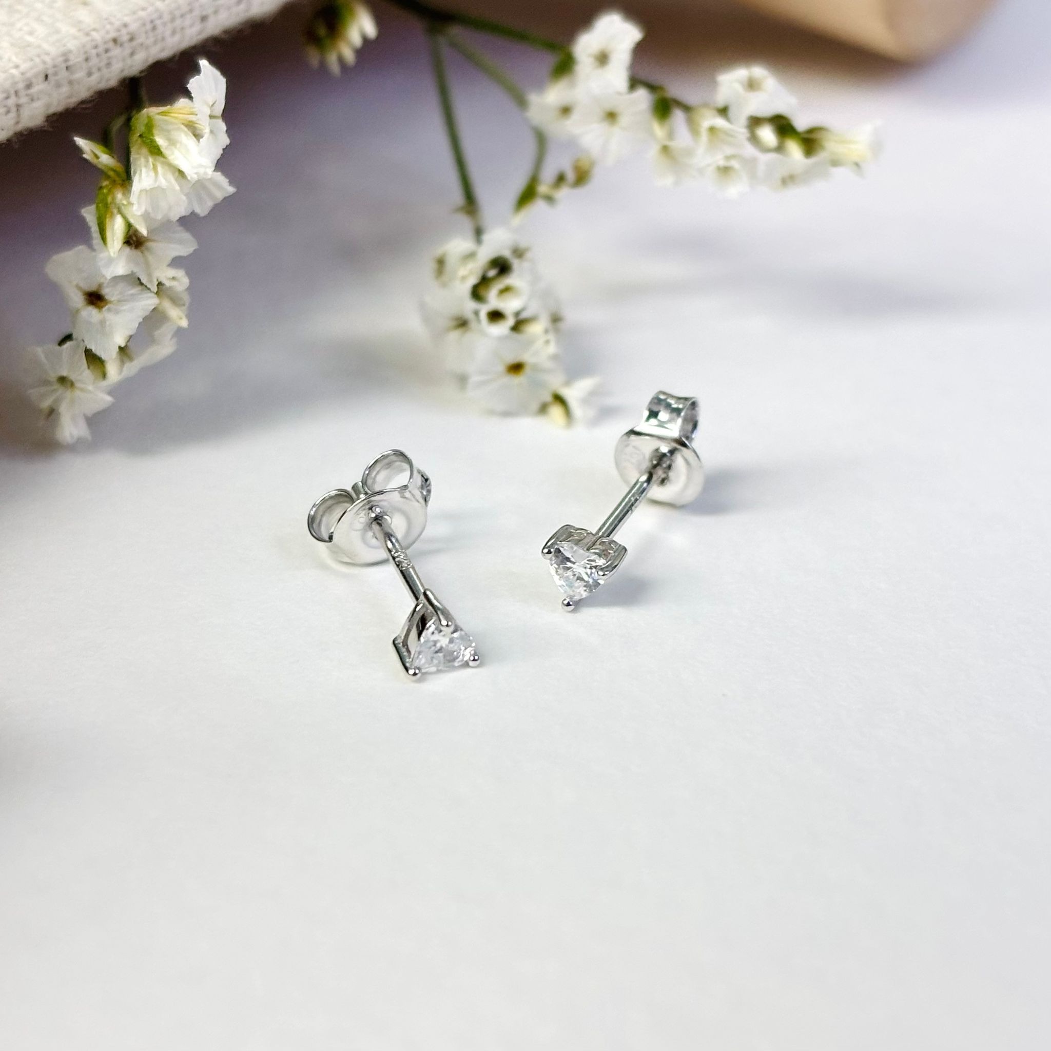 925 silver heart shape CZ stud earrings with a tiny sparkling design.