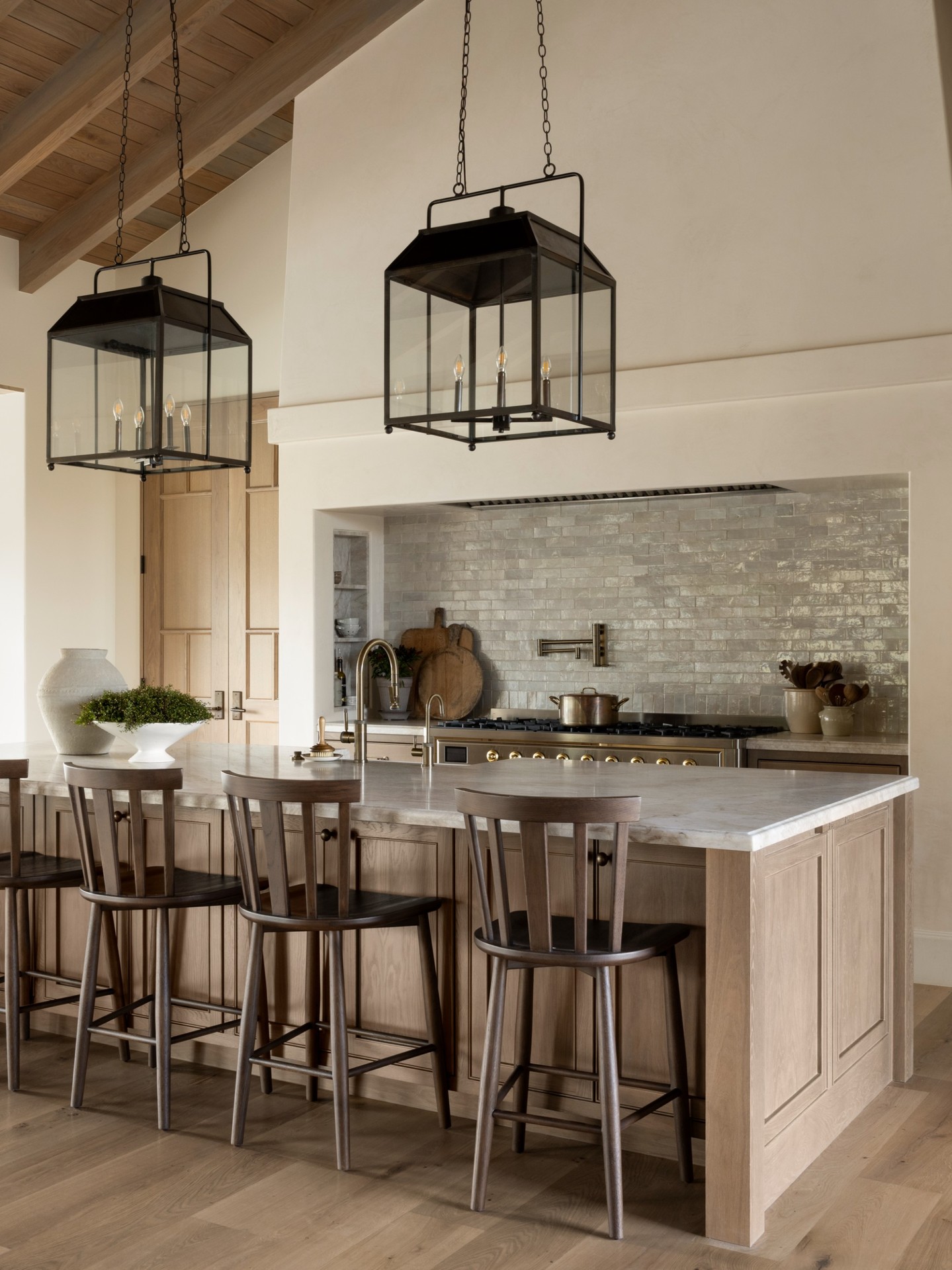 Willow Creek Estate's kitchen continues the home’s warm, inviting feel with a central island and coz