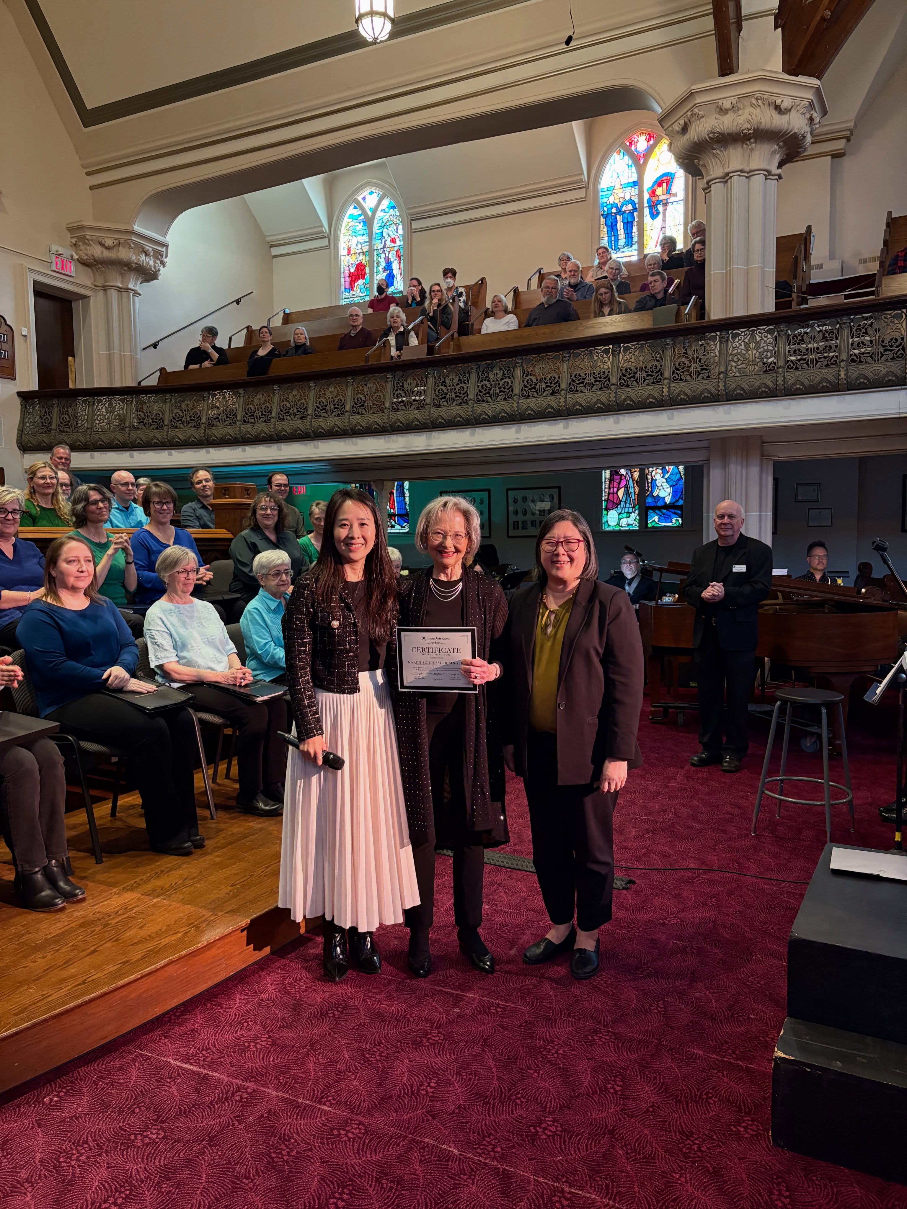 Last Saturday, we had the pleasure of attending a sold-out milestone concert for the Karen Schuessler Singers. With mixed emotions the choir performed the last concert in their 33-year history on May 2, 2026. Led by Artistic Director Karen Schuessler, the choir returned to the roots of what brought them together 33 years ago, singing the Missa Gaia/Earth Mass.
From the curation of the program and involvement of the audience to the dynamic performance and passion radiating from the choir and guest musicians, the concert embodied the choir’s signature style. We were so pleased to celebrate in such a meaningful moment for the choir and for the community. 🎶
As part of the concert we were proud to present the choir with a Certificate of Recognition for the significant contribution the choir has made as an arts organization in the London community.
Congratulations once again on an incredible 33 years! 🎉