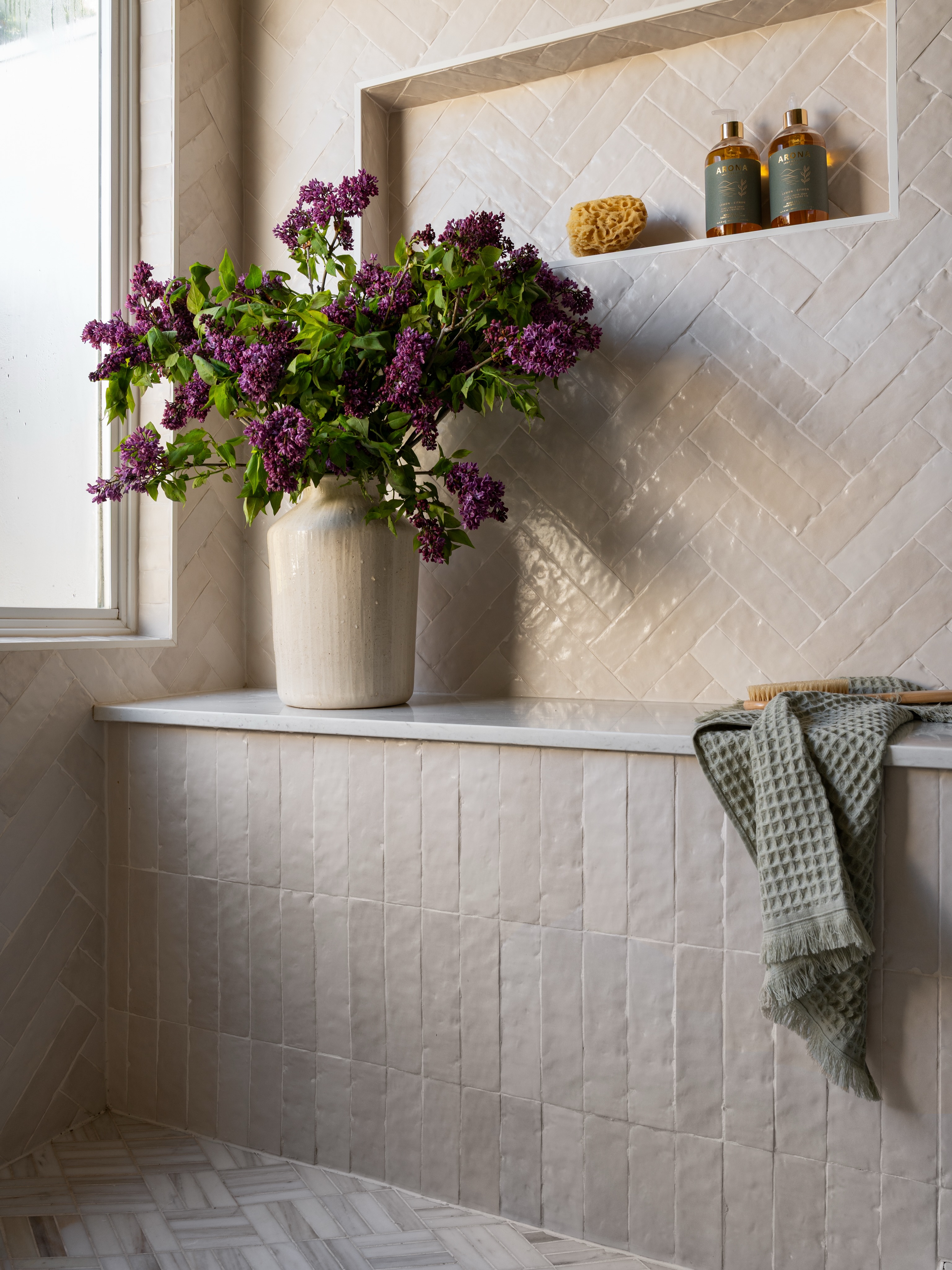 There’s something about a shower opening onto a little secret garden that makes the whole space feel like a boutique hotel 🤍
I’ll always love a pattern-on-pattern moment, and this bathroom was such a fun challenge because everything is tonal and neutral, so the mix has to feel layered instead of busy. The herringbone zellige walls, marble mosaic floors, warm stone, and oversized window all play off each other in a really subtle way.
It’s quiet but still has a point of view, which is usually my favorite kind of space.
Design @kiki_designstudio
Pc @charlotteleaphotography