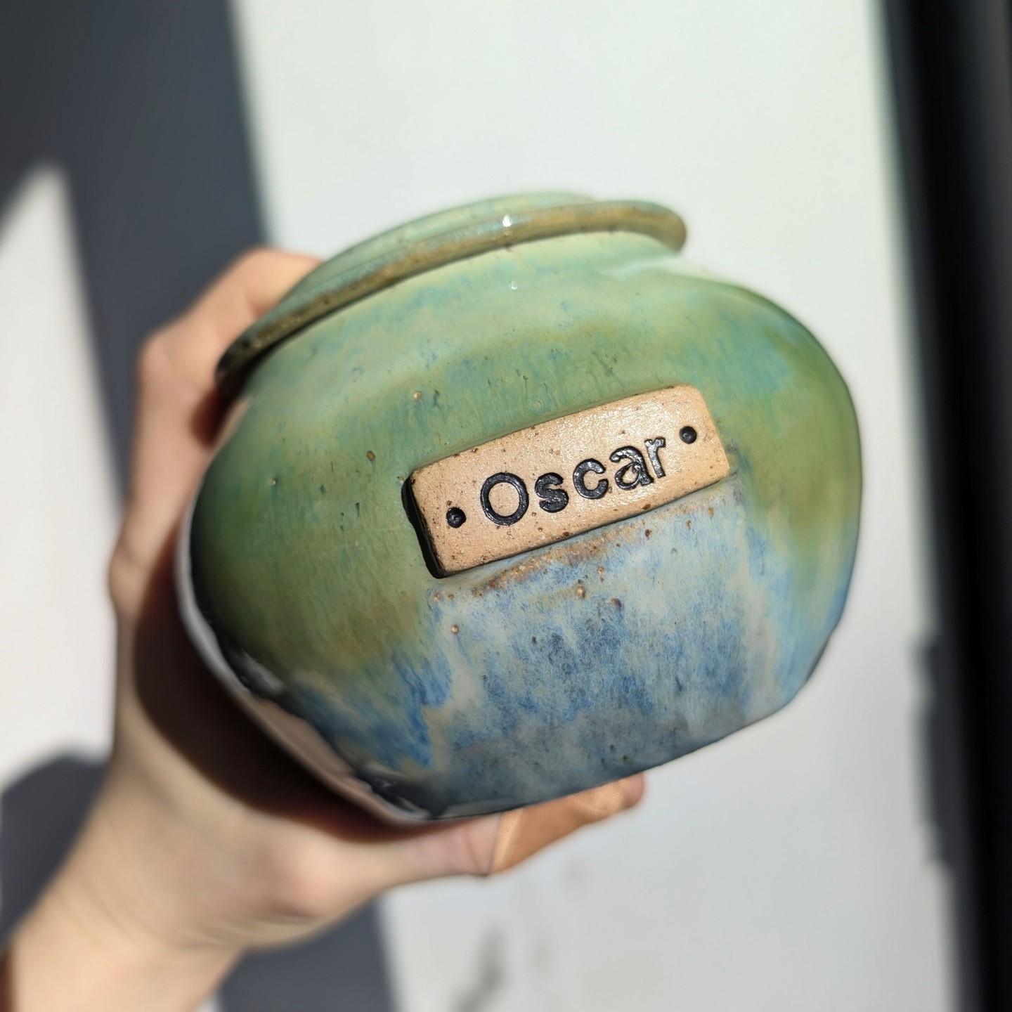 Another commission piece for you this week and proving the versatility of ceramics - an unusual request here but one I absolutely adored the opportunity to make.
This is a small custom urn and was designed for the ashes of a beautiful cat called Oscar. The blue and green colours featured were chosen as a tribute to him - blue to represent a male cat and the green a reflection of his striking green eyes.
The lid was also made to have a dedicated section to hold a little tealight candle - A functional piece, a treasured keepsake, and a beautiful way to keep his memory alive.
Swipe through to check out the details of the urn - the glaze gradient and the functional lid design.
