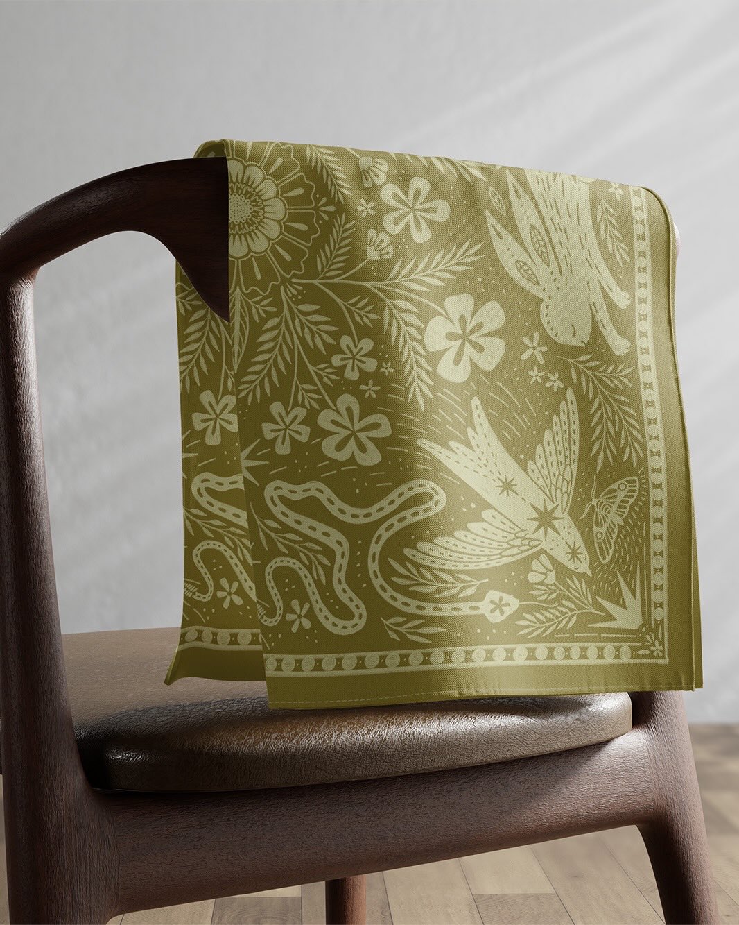 Inspired by vintage bandanas, quilt patterns, and prairie folk art, this design blends swallows, snakes, wildflowers, and stars into a mirrored composition in earthy olive and cream tones.
Named after the Latin word meaning “I yield” or “I accept,” Acquiesco reflects a quiet harmony with the changing rhythms of the natural world.