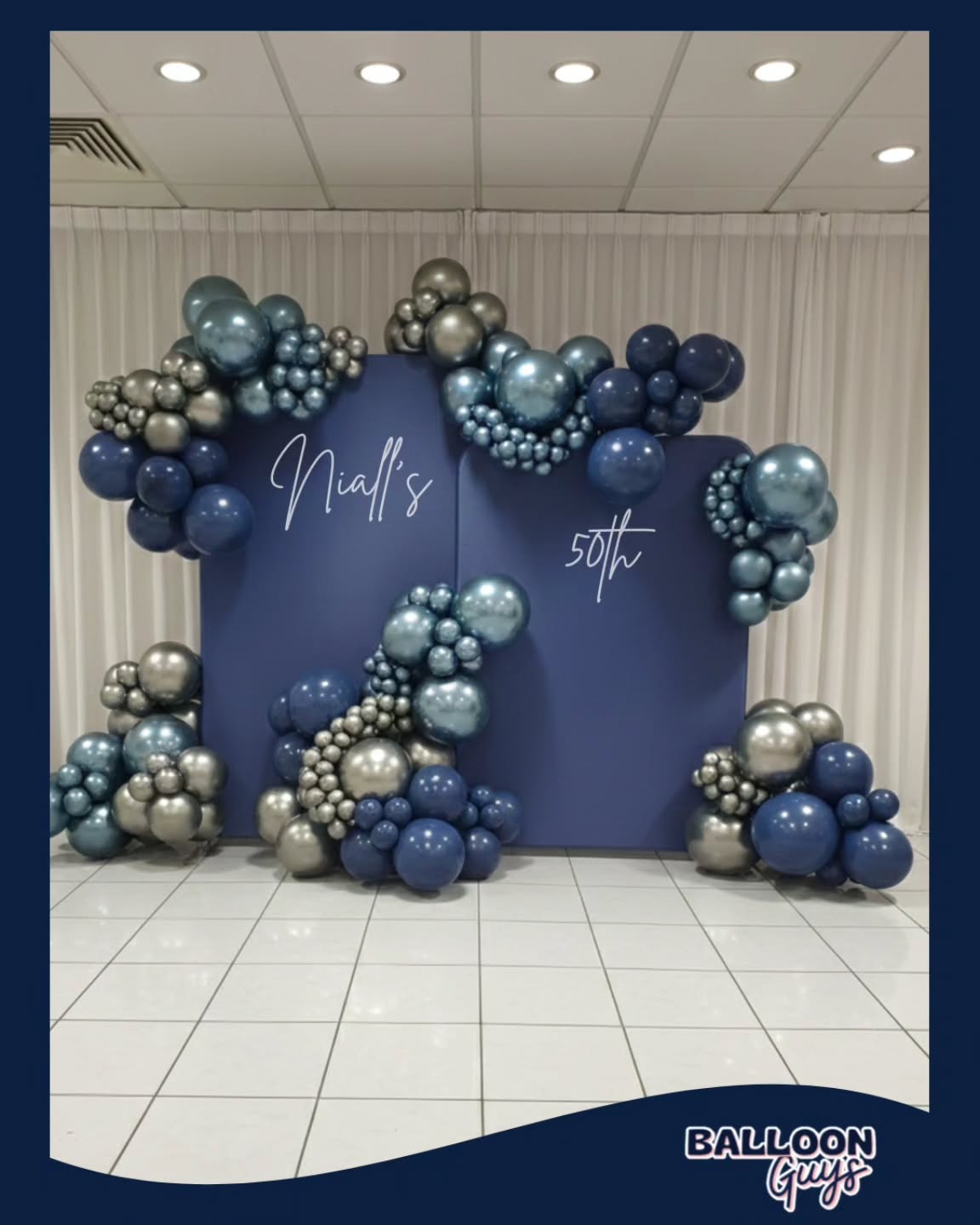 Getting the Details Right - Niall’s 50th
Let’s be real - we’re not anchoring structures to trees or engineering bridges here. But what we are doing is ensuring we use solid panel frames, clean backdrops & scripted font with a lot of fancy balloons. 🎩
But any installer knows that making a massive display of chrome & shaded blues look balanced, sharp, and perfectly grouped takes a proper eye for detail and a good few hours of hard work before and during the build. 📢
Guy and I wanted this 50th setup to look clean and high-end, and getting those organic clusters to sit exactly right against the velvet panels is where the actual craft comes in. 🎤
Huge thanks to the venue staff for giving us the room to get it done properly - working alongside good local teams makes all the difference.🎺
📆 Our calendar fills up fast. But don't feel rushed.
If you're planning a milestone event here in Hertfordshire or Whereabouts get in touch early is the only way to lock in your date and know it's secure. 🔐
www.balloonguys.co.uk
#50thbackdrops #husbands50th #turning50th #northlondon #luxurylifestyle