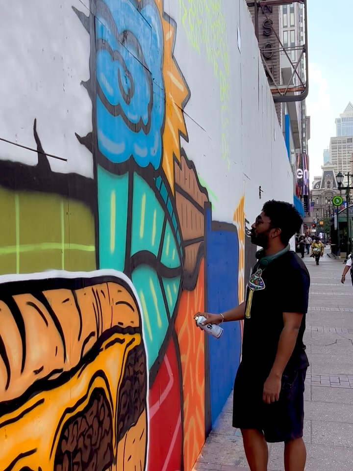 Take a sneak peek at the making of Alloyius McIlwaine’s latest mural at 10th & Market - a massive 150-foot “Welcome to Philly” installation coming to life in anticipation of the @fwc26philly World Cup ⚽️🏟️. The mural layers together Philadelphia’s history, culture, landmarks, and everyday icons into one bold visual story.
Watching the process up close gives an even greater appreciation for the scale, energy, and detail behind public art like this. Excited to see this become part of the experience welcoming visitors from around the world to Philly!
Amazing work @culturesclothing + @wheresthewater 👏👏
@muralarts @comcast @centercitydistrict