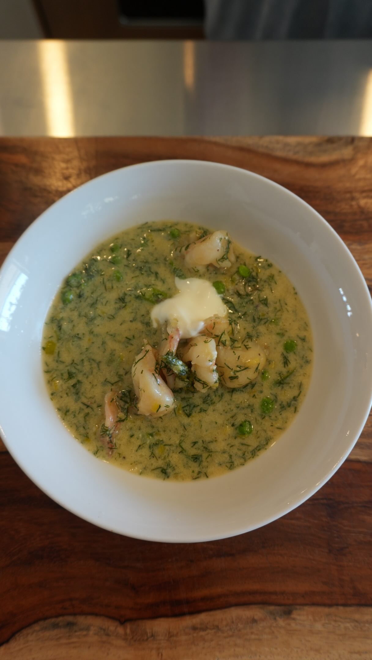 There’s something about this soup that feels like it carries more than flavor; it carries memory. My grandmother Nolan came from a German, Eastern European way of cooking where everything was practical, purposeful, and made with care.
And then she came to Florida and everything changed. She fell in love with shrimp. Suddenly, this ingredient that had never been part of her upbringing began to find its way into everything, folded into her cooking, woven into her traditions, as if it had always belonged there.
SHRIMP AND DILL SOUP:
4 T. unsalted butter
4 T. flour
1 cup leeks, cleaned and finely diced
2 T. garlic, minced
2 cups asparagus, diced into 1-inch pieces
1 cup chopped dill
4 cups chicken broth
¼ cup heavy cream
2 eggs beaten
1 cup crème fraiche, plus more for garnish
½ lb 21-25 raw shrimp, cleaned, tail off
½ cup frozen garden peas
Salt and black pepper
Lemon juice
In a medium pot, melt the butter over gentle heat. Add the leeks and cook slowly until soft and tender, without browning. Add in the garlic. Sprinkle in the flour and stir gently, letting it coat the leeks. Cook for 1–2 minutes. Slowly pour in the chicken stock, whisking as you go to keep the soup smooth. Bring to a gentle simmer. Add the asparagus and cook for 2-3 minutes, until just tender and still vibrant. Stir in the full cup of chopped dill and let it cook gently in the broth.
In a separate bowl, whisk together the eggs and crème fraîche until completely smooth. Temper with hot soup, then slowly stir back into the pot over very low heat until silky. Add the shrimp directly into the hot soup and let them cook gently for 2–3 minutes, just until tender and opaque. Add in the peas. Turn off the heat. Finish with lemon juice. Taste and adjust seasoning. Let rest briefly before serving. Place the soup in a bowl and garnish with crème fraiche. Enjoy!
#shrimp #soup #homecooking #recipe #chef