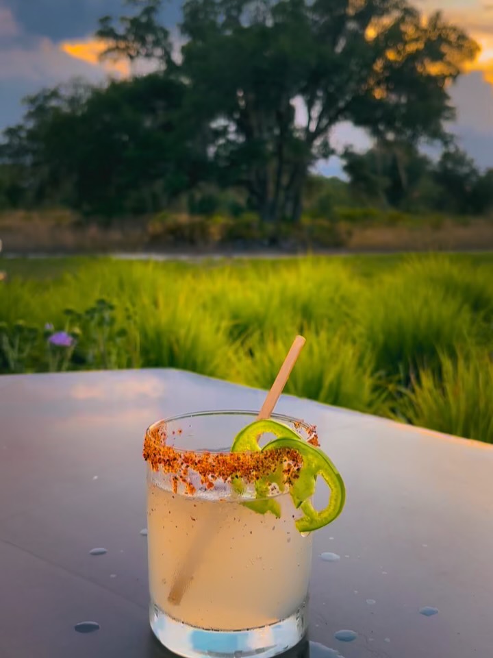 Golden hour hits different with a spicy mezcal Paloma and a view.