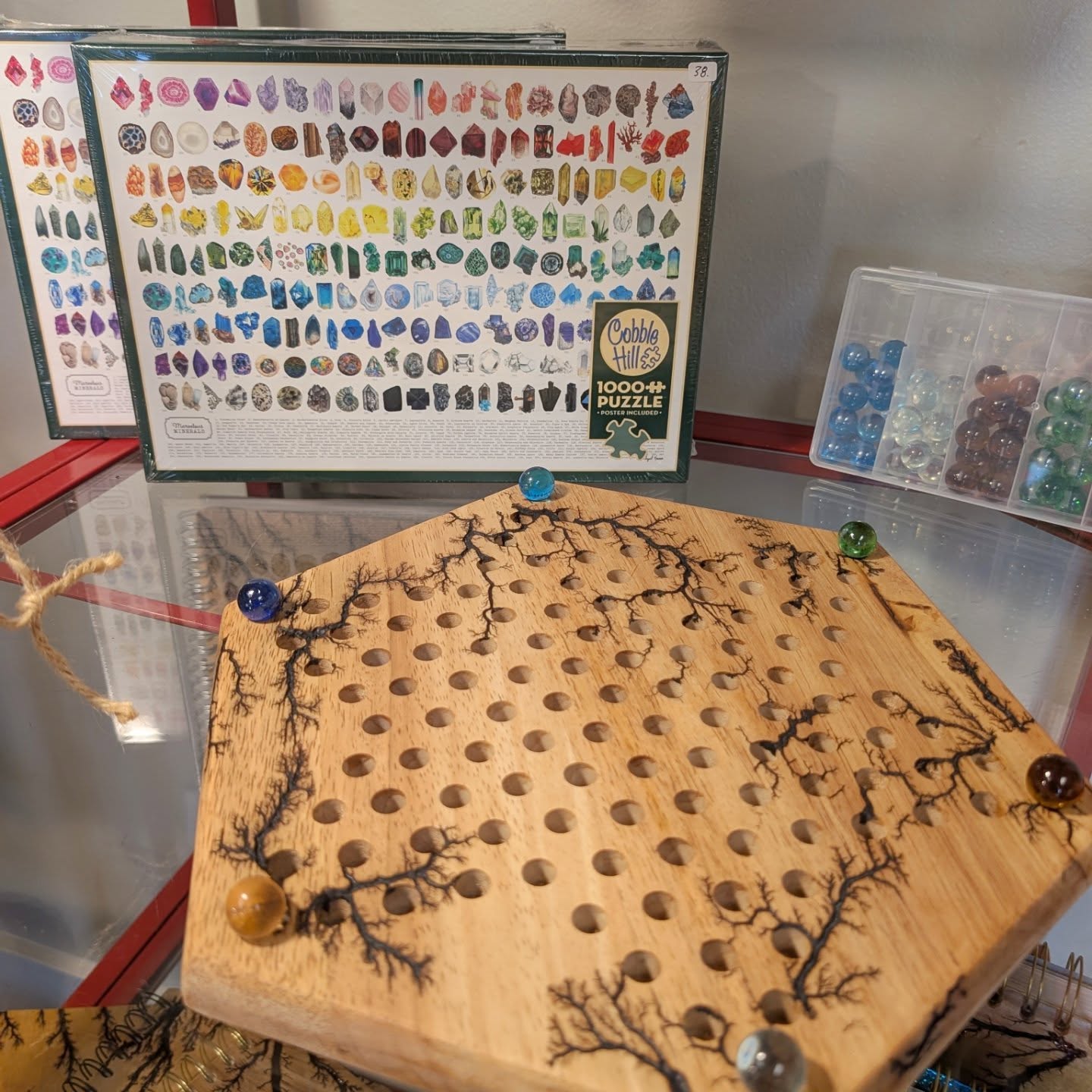 "Do something fun with someone you love" is the theme here, and that makes me smile!
I have admired Abi Kramer's @twiggyabi watercolor and mixed media art for a long long time. I brought in a couple of her beautiful "Marvelous Minerals" 1000 piece puzzles to help highlight Suzannah @lightningtreedesigns super fun "electrified" Chinese checkers set. Not that it needs help - it's brought many many smiles here in the LM Pop-Up @mountvernonwa #magicskagit
