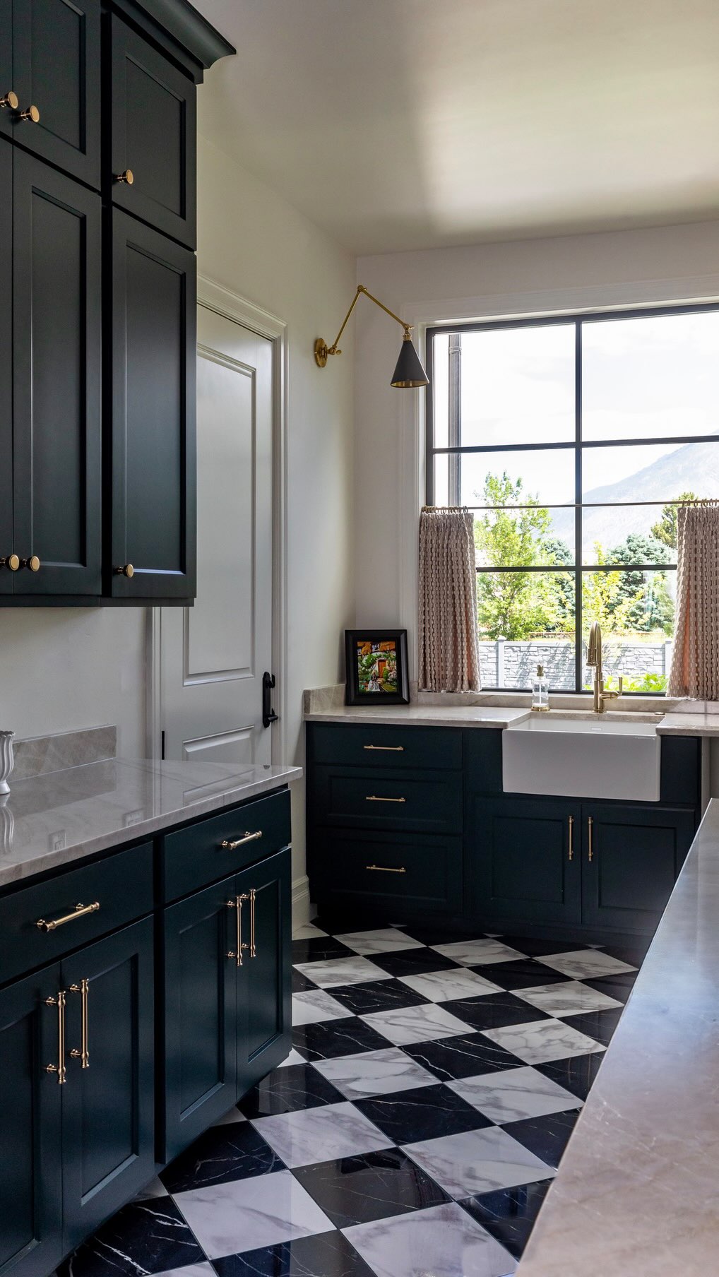 There’s something about the perfect moody paint color that completely transforms a space. Salamander by @benjaminmoore is one of those shades that feels rich, timeless, and full of depth. Depending on the light, it pulls both deep green and blue tones, giving the room a layered, elevated feel that changes throughout the day. Dark and dramatic, yet somehow still calming — the kind of color that makes every detail around it feel intentional. #moody #paintcolor #pantry #scullery #pantrydesign