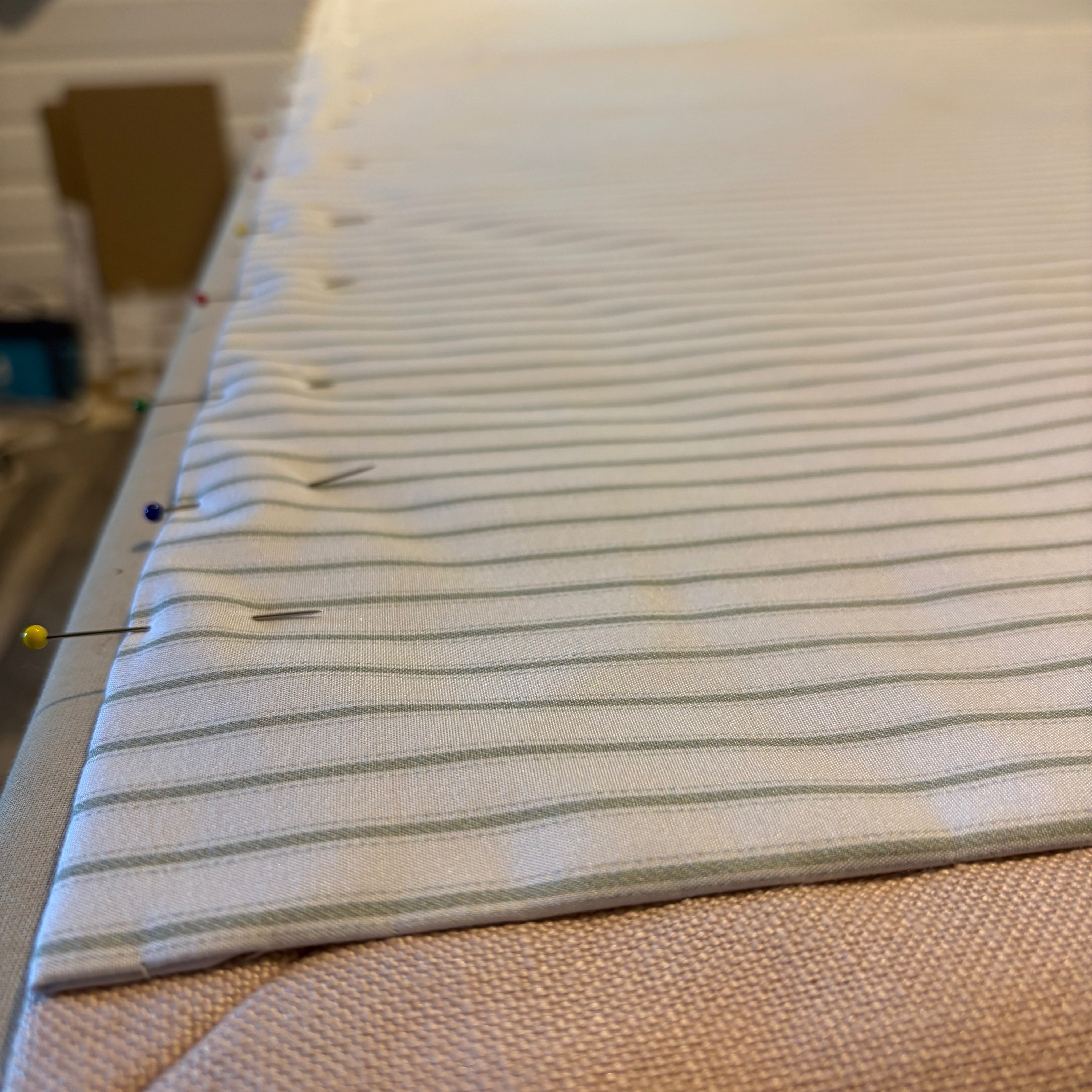 When the back of the curtain is just as beautiful as the front. 🤍🪡
A rare moment where the workroom table is clear enough (and big enough!) to lay out two full pairs of interlined curtains at once.
These are an absolute joy to work on. This lovely, soft pink face fabric is paired with a contrasting sage green ticking stripe lining. It adds such a fresh, unexpected pop of pattern from the outside looking in.
Swipe to see hand finished craftsmanship. Those crisp, perfectly mitered corners, weighted hems, and completely invisible hand-stitching. It’s what gives interlined curtains that luxurious, substantial weight.
#CurtainMakerCornwall #TickingStripe #MiteredCorners #BespokeCurtains #HandStitched #WorkroomLife #LiningDetails #PinkAndSage #QuietLuxury