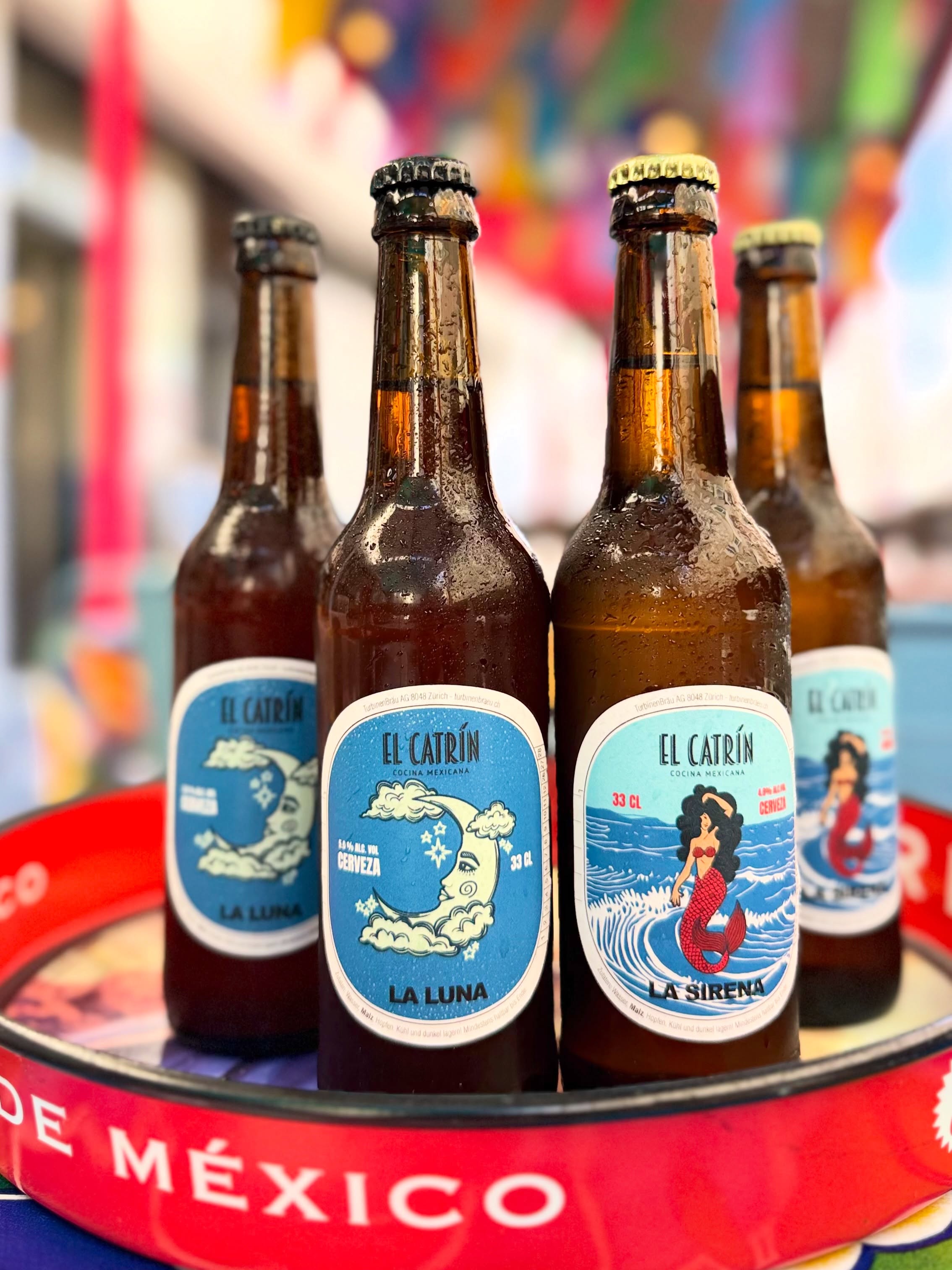 ☀️🍻 Terrace season is here, and there’s no better way to enjoy it than with our exclusive craft beers.
Inspired by two of the most iconic characters from the Mexican lottery, we proudly present La Luna 🌙, our dark beer with a bold character and roasted notes, and La Sirena 🧜♀️, a fresh, light lager that’s perfect for sunny days.
Specially brewed for us by the renowned Brasserie Turbinenbräu in Zurich, these beers reflect the fusion of Swiss brewing tradition and the magic of Mexican culture.
Come discover them, raise a glass with friends, and enjoy the summer on our terrace. 🍻✨
#ElCatrinGeneva #CraftBeer #Turbinenbrau #MexicanVibes #TerraceSeason