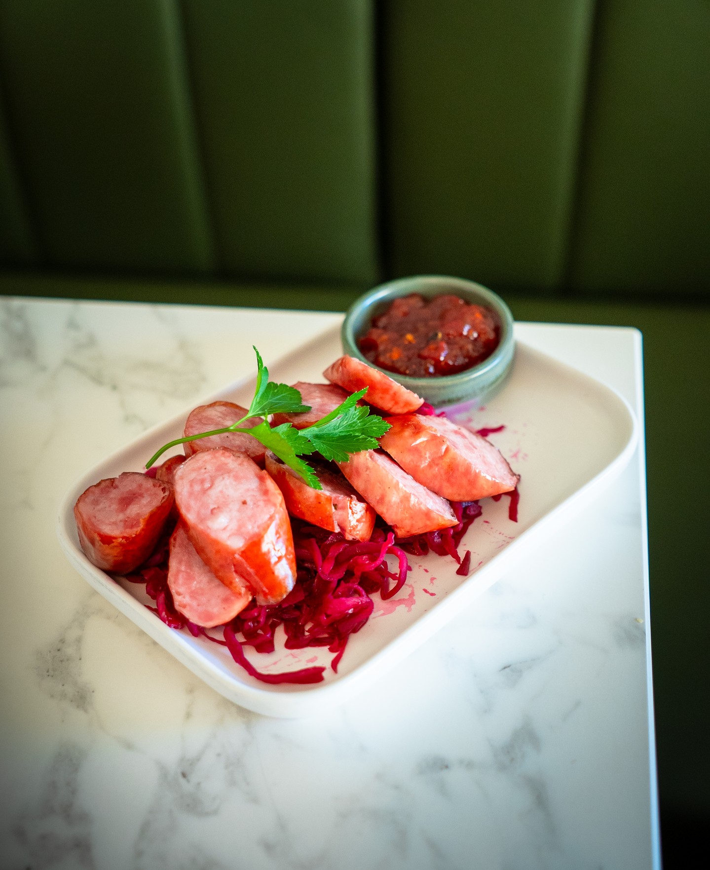 Sausage of the day is a new addition to the tapas menu at Woodend Cellar & Bar.
Sliced and served on fermented cabbage with a tomato and jalapeño relish on the side: straightforward, well-seasoned bar food that changes with what's available locally. The kind of dish that pairs as well with a glass of Pinot as it does with a cold beer.
#woodendcellarandbar #macedonrangestapas #woodendfood #macedonrangesbar #woodendvictoria