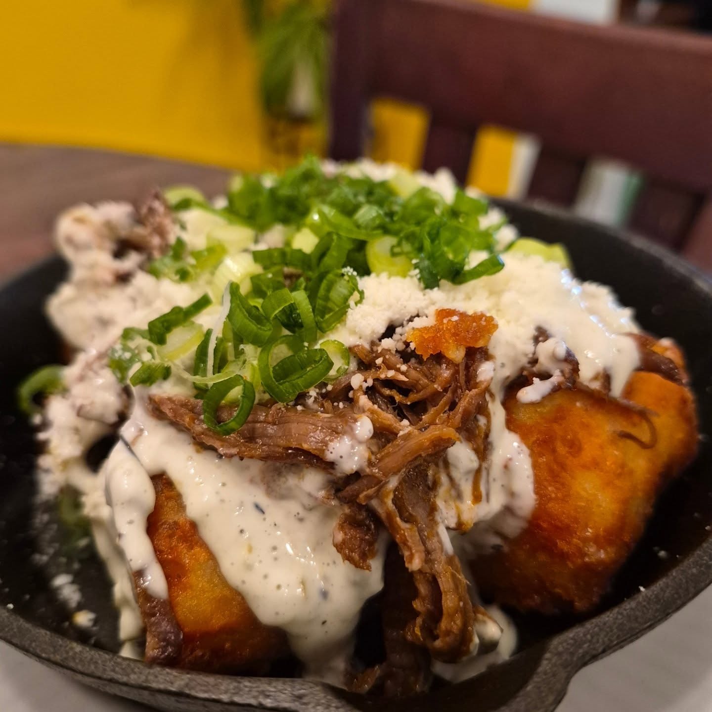Serious question! Do you like cheesy potatoes, slow braised beef, and jalapeños? If you do this is just the thing you need! Cheesy tots, cooked in beef tallow, topped with slow braised beef, jalapeño mayo, cotija cheese and hella green onion!