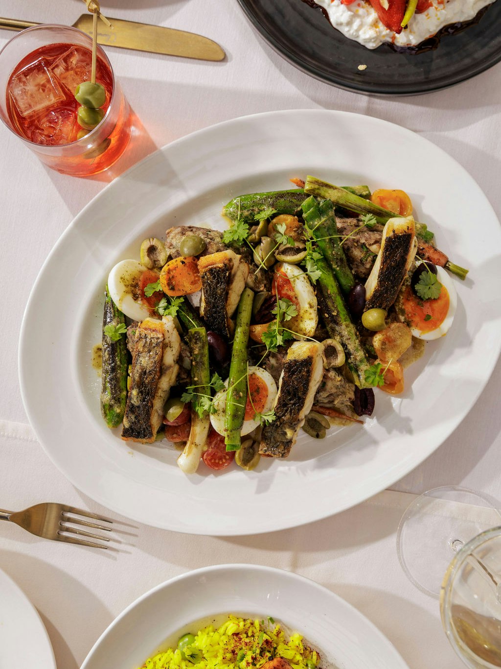 A quintessential summer dish, reimagined with a Middle Eastern twist - stone bass “niçoise” with Jersey Royal potatoes, baby courgette, and a preserved lemon and garlic dressing. 🌞