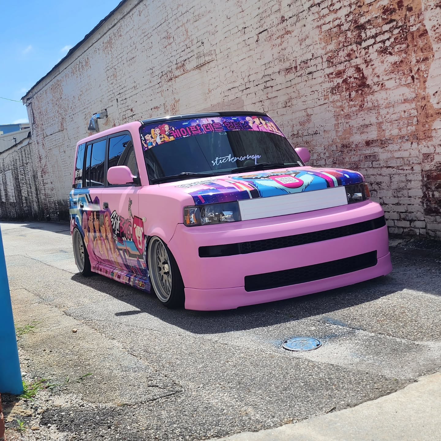 Story Time: I knew I had to do something completely different this year, and deep down I knew it was finally time to change the itasha wrap for MomoCon 2026. I just wasn’t sure what direction to take at first, but I knew it had to stand out from anything we’ve done before.
One day, my daughter was getting ready for school, but she refused to wake up unless I played the “Golden” song from KPop Demon Hunters. On top of that, she would only wear pink from head to toe before leaving the house. That’s when everything clicked. She inspired the entire new color theme for the Scion xB and pushed me to create something totally different from what people are used to seeing from us.
Tony from Digital Print Design took the vision and created the artwork completely from scratch with over 13 characters, carefully making everything flow together while even adding their names in Korean lettering for extra detail and authenticity.
The process wasn’t easy either. It took us about 4 weeks to fully repair the vehicle, replace parts that needed attention, and make sure the wrap and digital print installation came out exactly the way we envisioned it. Every detail mattered, and we wanted everything perfect before revealing it.
Once it was finally complete, we kept the vehicle hidden until Caffeine and Octane, but especially for the official MomoCon reveal, where we could display the Scion xB and show everyone the level of work and creativity we’re capable of bringing to the itasha scene.
And now, here we are. Time to finally show it off and let all the hard work pay off.
#anime #itasha #kpophunter #scionxb #bagged