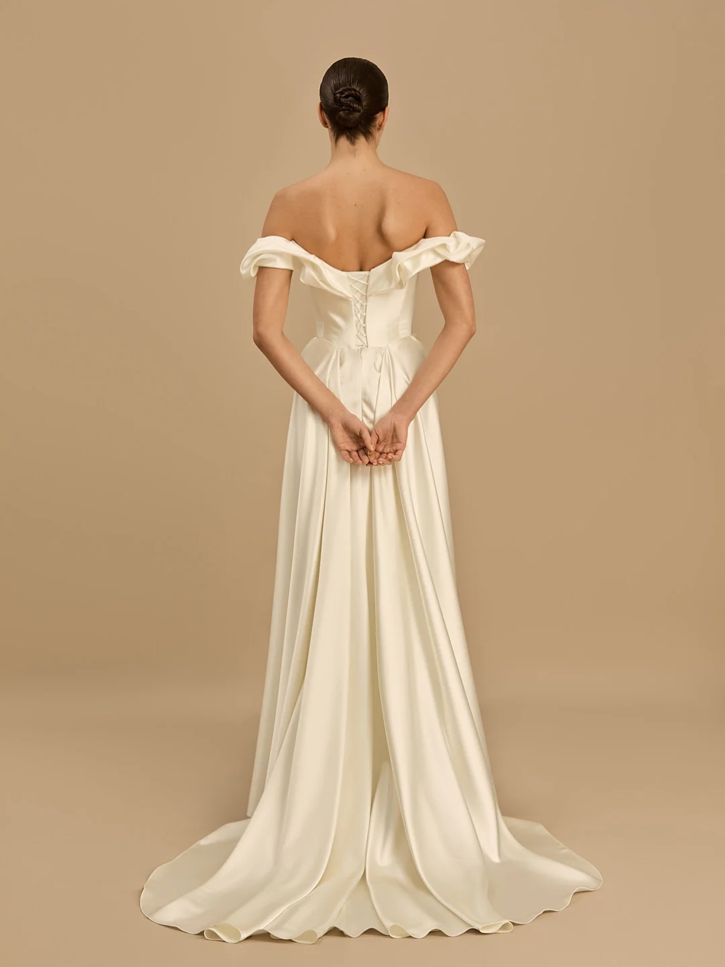 Celine by Rouvell *COMING SOON*
For the bride who wants simplicity without disappearing into it. Celine pairs a softly draped off-the-shoulder neckline with sculptural detailing through the bodice and hips, creating a silhouette that feels effortlessly elegant.
Cut in luminous satin with a fluid skirt and sweeping train, she’s proof that a plain dress never has to mean boring. Modern. Refined. Unforgettable.