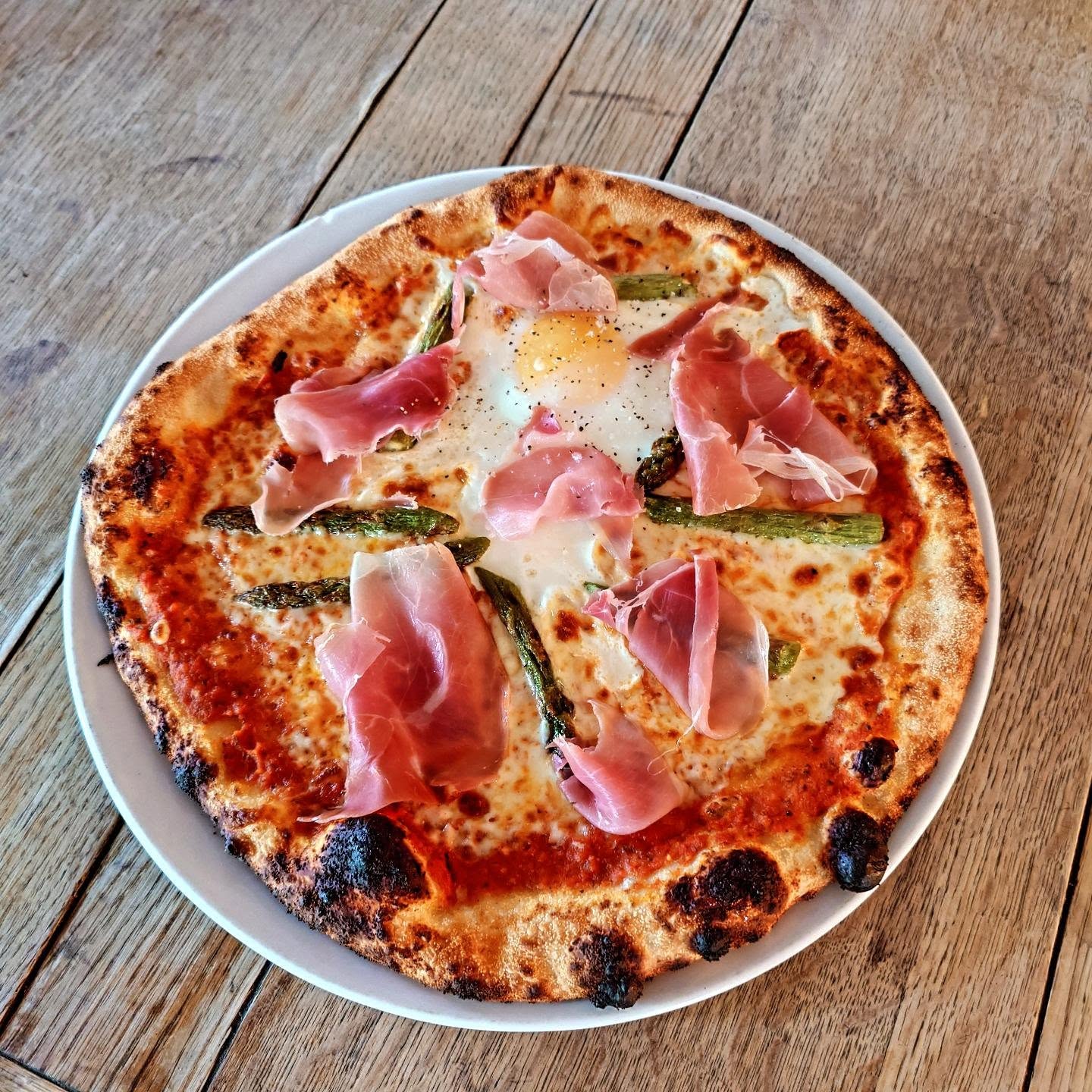 Pizza special. Asparagus, prosciutto & egg. Hand stretched and baked to perfection