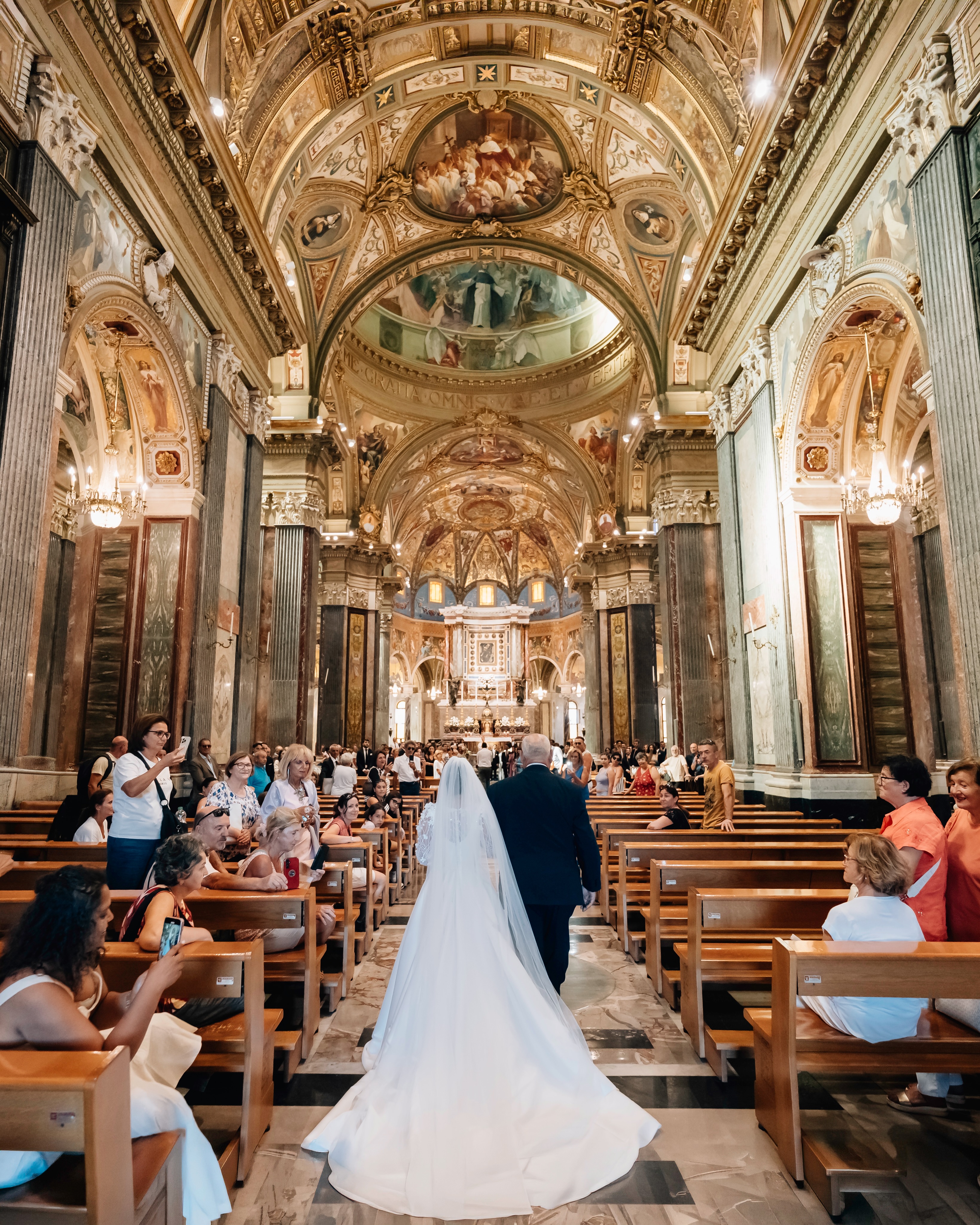 📸 Photo: @francescoartistico.it
One of the secrets of timeless wedding photography is allowing architecture to become part of the narrative. Every line, every arch, every painting inside the Sanctuary of Our Lady of the Rosary of Pompeii leads toward a single moment: a father accompanying his daughter as she takes the final steps before saying “I do.”
Uno dei segreti della fotografia di matrimonio senza tempo è lasciare che l’architettura diventi parte del racconto. Ogni linea, ogni arco, ogni affresco all’interno del Santuario della Beata Vergine Maria del Santo Rosario di Pompei conduce verso un unico momento: un padre che accompagna sua figlia negli ultimi passi prima del suo “sì”.
#weddingphotographeritaly #destinationweddingitaly #italywedding #weddinginspiration #weddingstorytelling