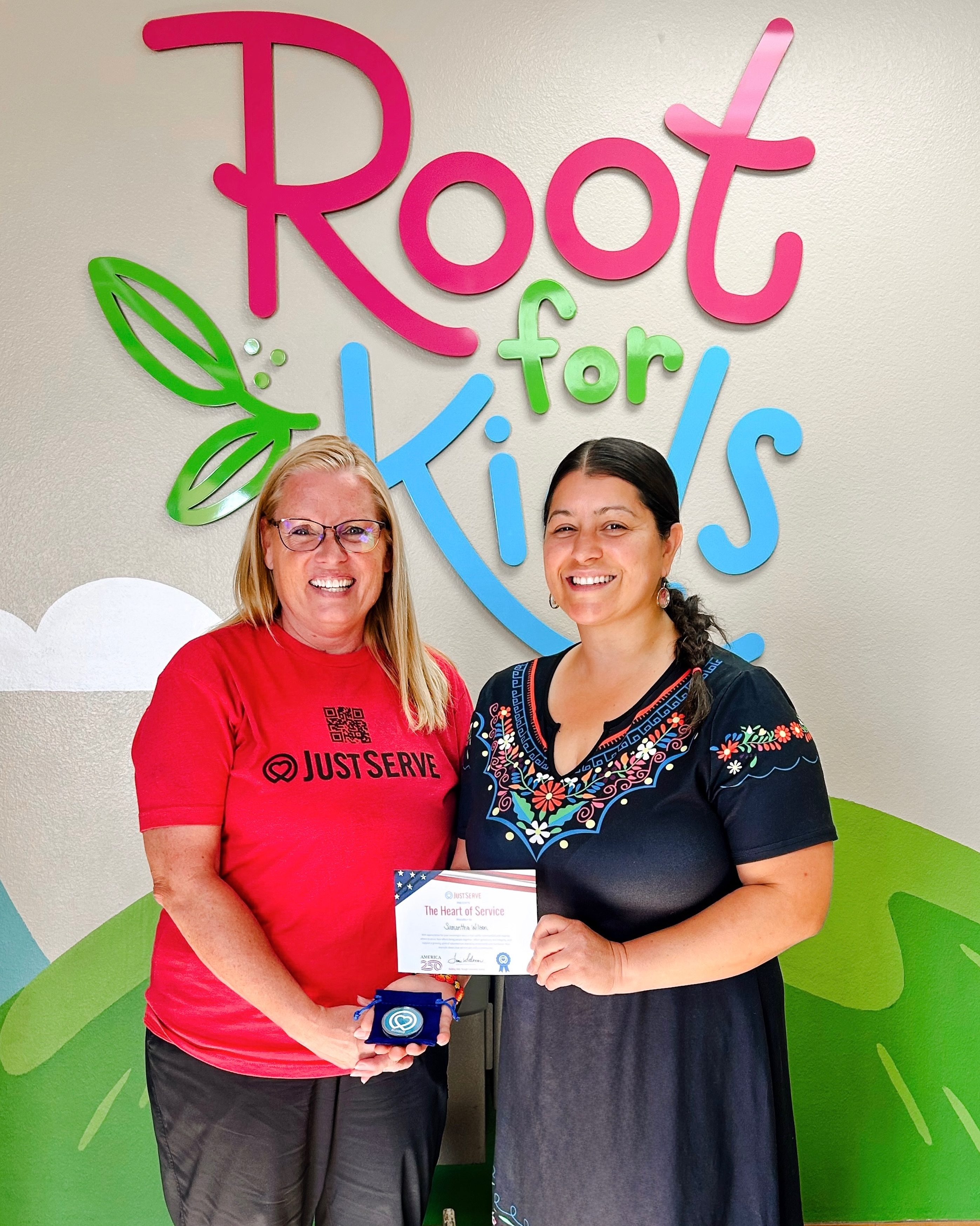 We are very proud to celebrate an incredibly special recognition received by one of our own, Samantha, who was recently honored with the @justserve “Heart of Service” Award!
JustServe selected Root for Kids from several organizations in recognition of the incredible impact our volunteers and team continue to make throughout the community, and so much of that heart and connection starts with Samantha.
Anyone who knows her knows this recognition could not be more deserved! She has one of the biggest hearts of anyone we know, and the passion, compassion, and care she pours into her work each day touches so many lives. She goes above and beyond for the families we serve, our volunteers, and our community, and we feel so lucky to have her as part of the Root for Kids team!
Samantha, thank you for the love and dedication you bring into everything you do! 🩷💚🩵