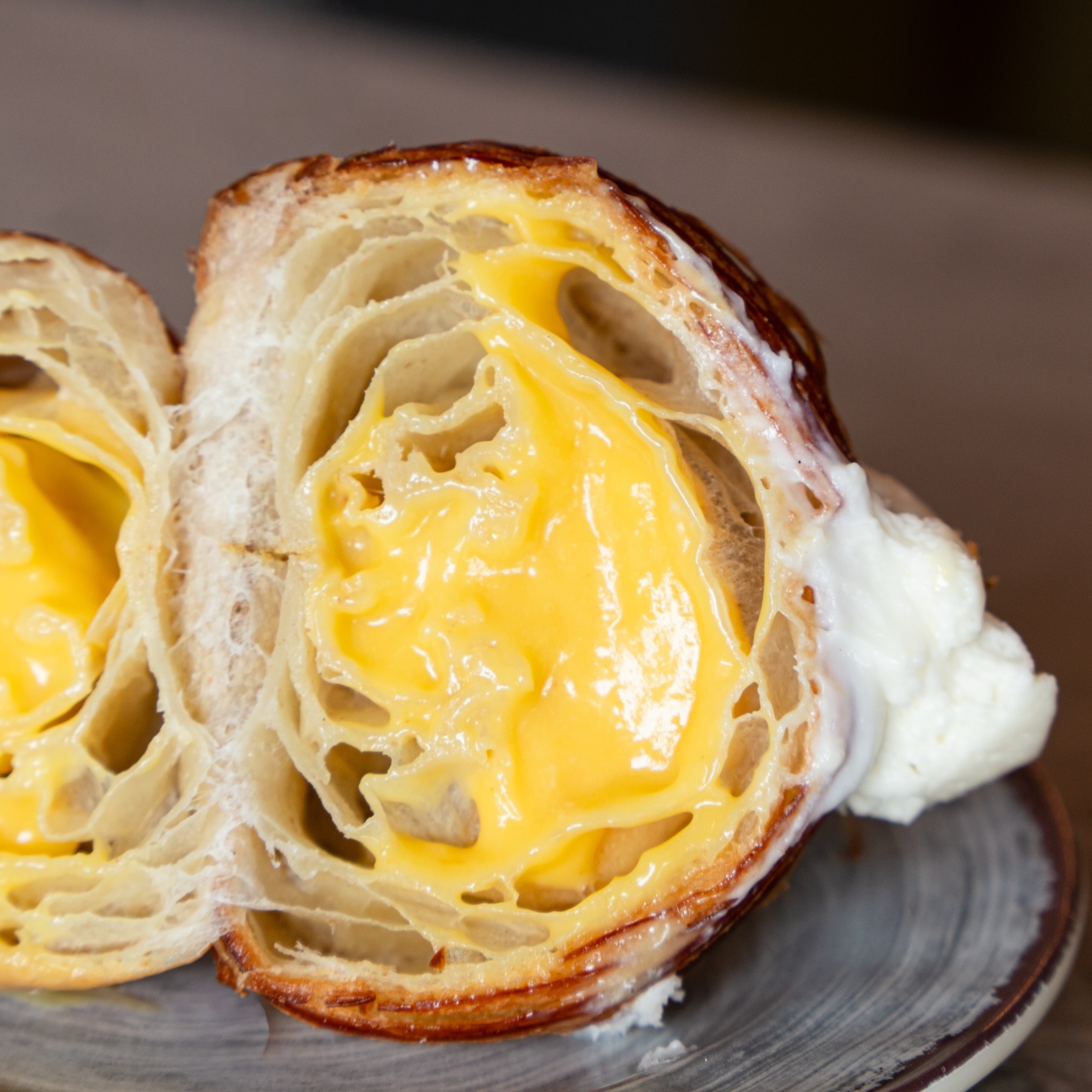 Tart, sweet, and a little unexpected. 🥐 Passion fruit curd filling, white chocolate ganache, our June special that’s been getting a lot of attention.