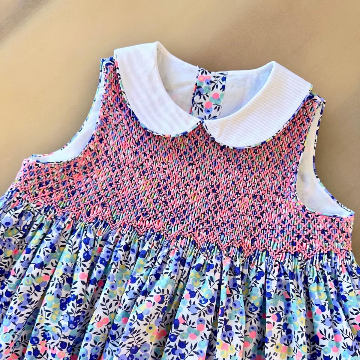 A Smocked Sleeveless Sundress 😍☀️
The Olivia Sleeveless dress is a new look for the classic bodice dress smocked from the shoulder. A Peter Pan collar beautifully finishes the neckline, while the back closes with buttons and a continuous bound placket. This add-on is not a stand-alone pattern, but rather a new bodice that can be constructed and used in place of the original bodice in the Olivia pattern.
Happy Sewing!
#ccpolivia #sewingforgirls