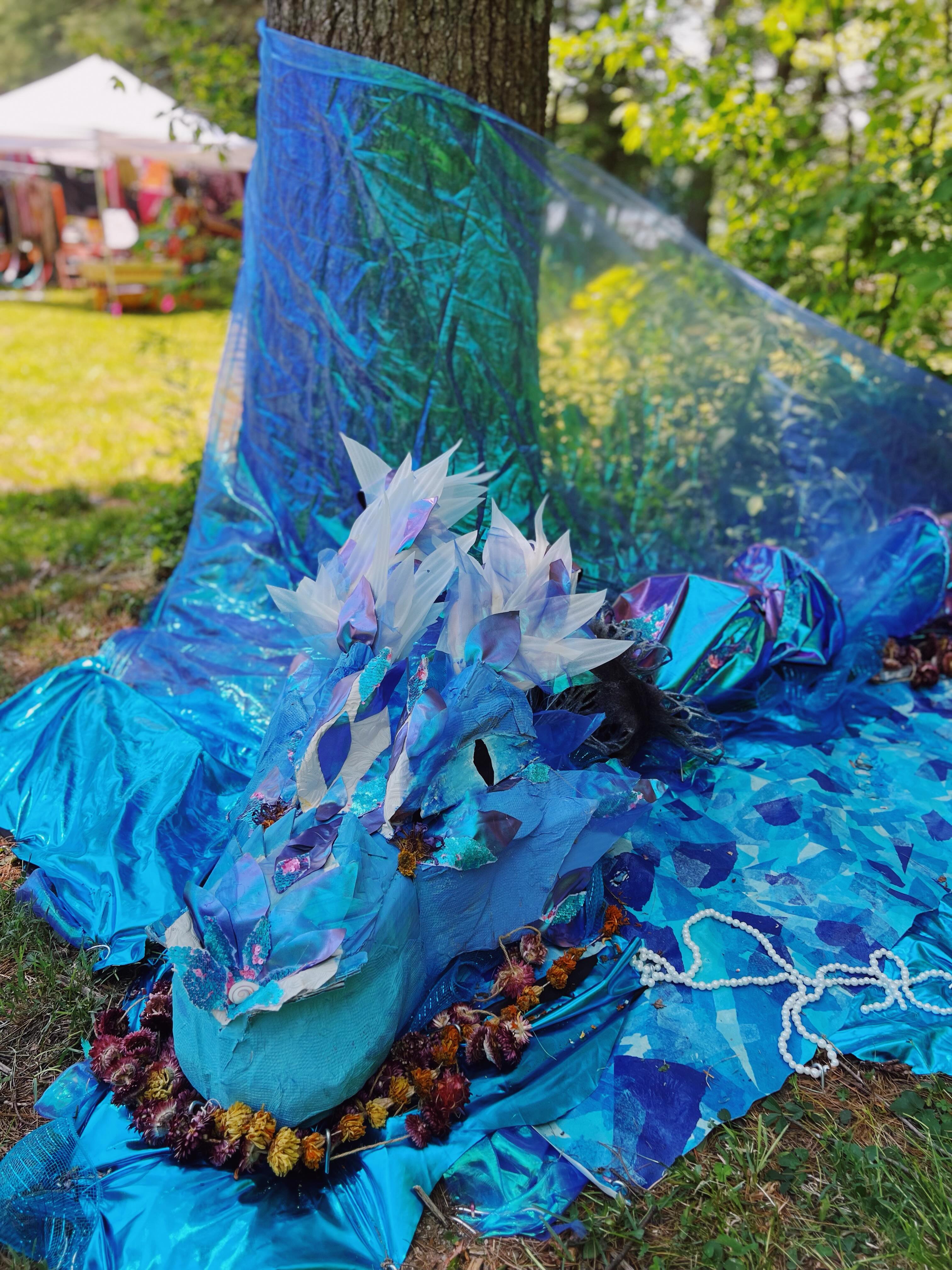 I brought to life a vision i had during my first night of aya when i opened my dieta in April. In my vision I swam down the amazon river and found a secluded lagoon. I became a water dragon serpent and swam in perfect bliss. I was water.. water was me.. and I was at one with the world. Oxum, yemanja, and oxumare all moved through my scaled and winged body. I was and am magic. Dragons have become increasingly present in my life these last 3 years. They love amongst us ;)
Thank you @dance.beyond for giving me the opportunity to bring to life this dragon vision and art installation 🥰🐉🌊
Thank you @keelia.ryan and @inkdog for your artistic contribution. Keelia helped me sew onto the sails and cut fabric for hours. Becca created the cardboard base for the dragon head for a project I put together last year (shoutout Elemental Existence!)
Actually all the fabric is upcycled from Elemental Existence.. a festival and ritual theatre devoted to celebrating the elements. This was a living work of art + liiiiit party i put together centered around a play i wrote, directed, and stared in last summer.
Thank you to my honey @thesunshinegroup .. Brandon came along and helped me make sure the dragon was maintained, taken care of, and taken down properly throughout / after the fest. We will be at Lunaburn in a few weeks with this install.. and some additions.. come say hi to us there and meet this water dragon .. you might even catch a music set of ours if you be blessed hehe💦🐉😛🥳
Thank you ayahuasca for the endless gifts you give me. Including the inspiración to create art and make music. You are the reason I am able to step fully into this human experience and not a day goes by where I don’t remember you!
Yemanja! Oxum! Oxumare! Thank you water! May all beings have access to clean water. 🫂🌊