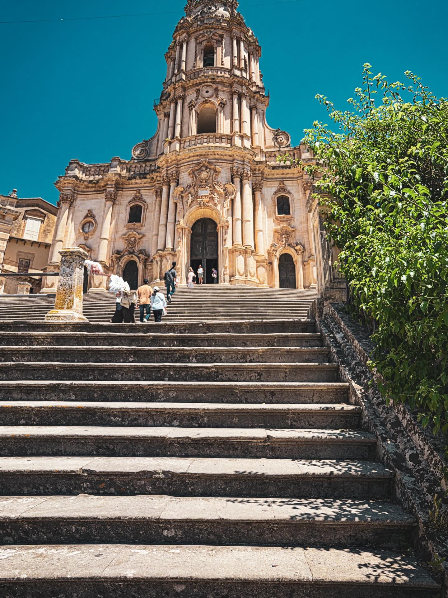 Modica was a town on Matt’s list. Apparently, they are well known for their chocolate! So, after we checked out of our Airbnb in Ortigia, we headed inland some. What we found was an incredible chocolate shop where we tried various chocolate bars, we each got a cannoli filled with chocolate cream, and finished it off with a cold chocolate beverage topped with cream (similar to a hot chocolate but almost as thick as a pudding).
After that indulgence, we needed to walk it off! Luckily, the town is a combination of steep windy streets and oh-so-many stairs! We wandered and explored - all the way to the top of the town. Since we did that during the siesta time, town was really quiet. There were so many nooks and crannies to explore!