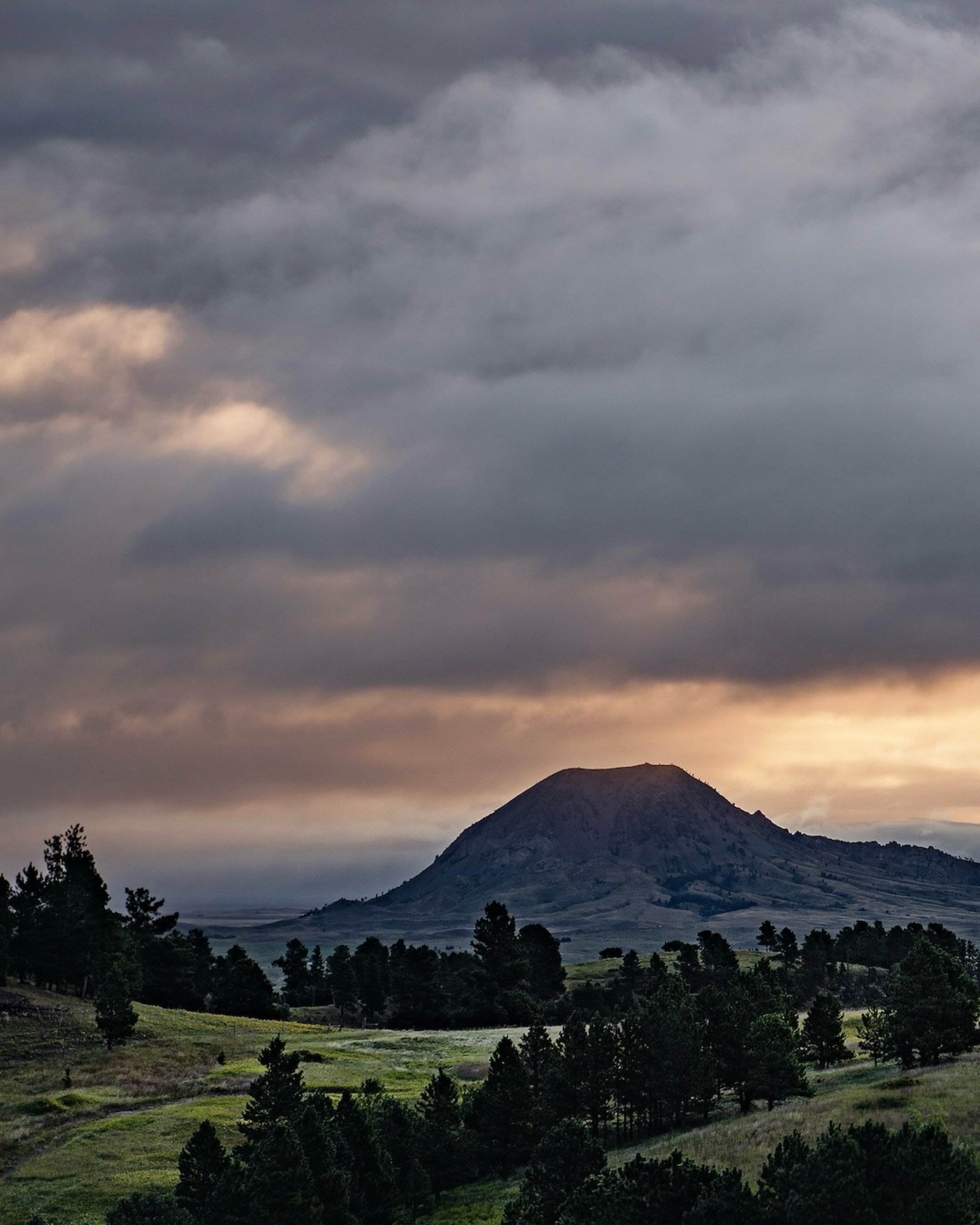 I can’t believe tomorrow kicks off Spearfish’s Annual Festival in the Park! 😱🙌🏼
To celebrate, I had to share one of the pieces that always stops people in their tracks at this show: Bear Butte Morning.
This year I’ll have it on display as a Metal Pro print, and I’m already curious who will be the one to take it home. 😉 If it sells before you get there, or if you’d prefer it in a different size or presentation, we can absolutely create the perfect piece for your space!
One of my favorite parts of being a landscape photographer is that every image carries a story.
Bear Butte Morning takes me back to September 12, 2019. I had spent the night camping in the southern Black Hills and was heading back toward Spearfish before sunrise. I honestly can’t remember why I was awake that early… but I’m incredibly grateful I had my camera with me instead of watching the sunrise from a Walmart parking lot, which, if we’re being honest, has happened more times than I’d like to admit. 😂
As I drove past Sturgis on I-90, I noticed Bear Butte beginning to glow with the first light of day. I immediately exited the interstate and followed a dirt road, hoping it would lead to a clear view of this sacred landmark.
It did.
As I crested the hill, an entirely new perspective of Bear Butte unfolded before me, completely free of any other man-made distractions. It felt like discovering a view that had been waiting patiently to be found.
Then, just when I thought the morning couldn’t get any better, I turned around…
A rainbow had formed behind me.
Those are the moments you never plan for, yet they’re the ones that stay with you forever. They’re why I keep chasing sunrises, taking dirt roads, and carrying a camera wherever I go.
Now I get to relive that morning every time I see this piece hanging in someone’s home, and I hope whoever takes it home next feels a little of that same wonder every time they walk past it.
📍I’ll be at Spearfish Festival in the Park all weekend:
• Friday: 4–8 PM
• Saturday: 9 AM–6 PM
• Sunday: 9 AM–4 PM
If you’re coming, stop by and say hello! I’d love to hear which piece speaks to you most.