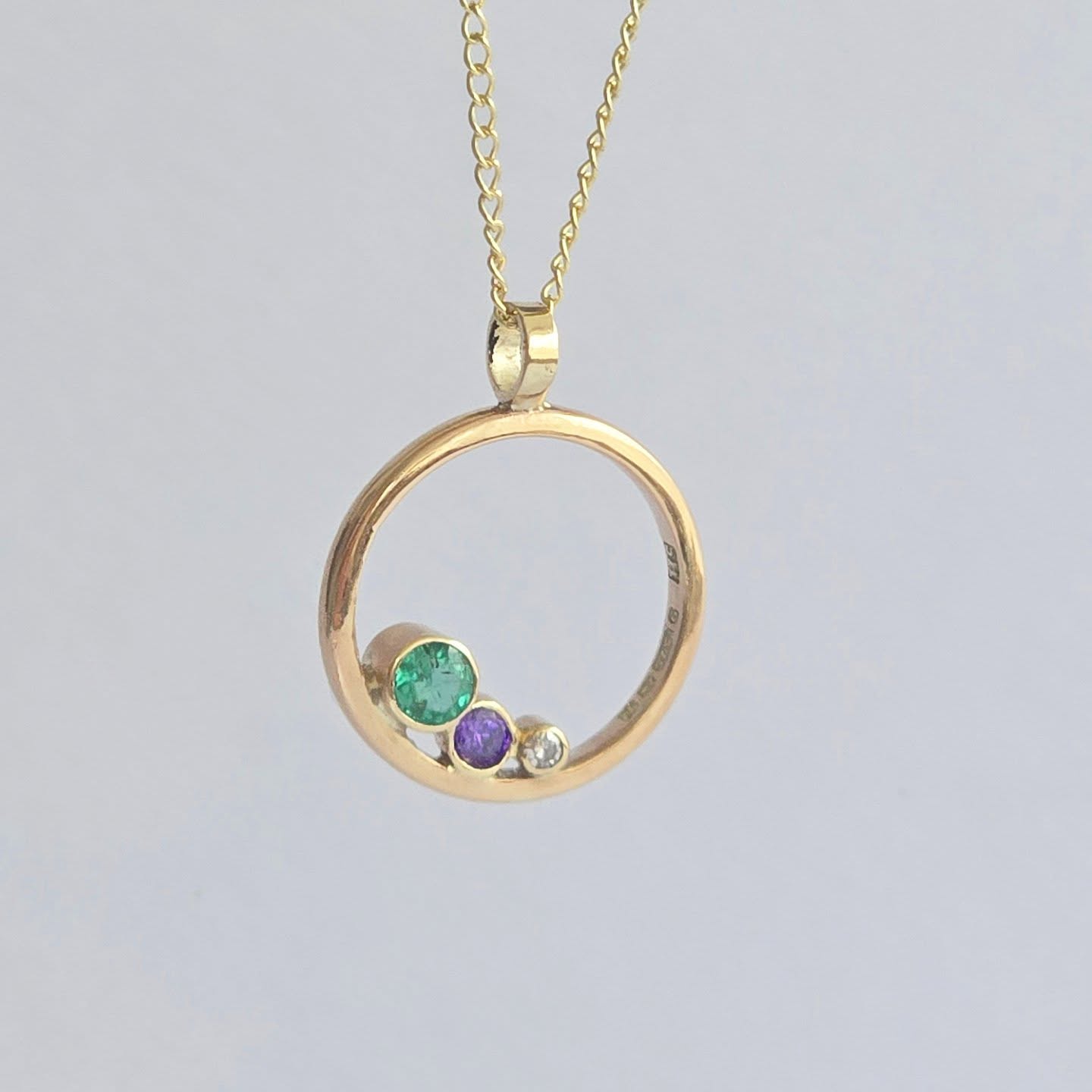 My customer came to me with a treasured 9ct gold wedding ring and another ring containing a small diamond. She wondered if I could transform them into a necklace she could wear every day.
Rather than melting down the wedding ring, I suggested preserving it exactly as it was. Instead, I created a design inspired by my Eternity Pendant, setting the diamond alongside two meaningful birthstones within the circle of the wedding ring.
The rich green emerald and deep purple amethyst sit beautifully together against the gold, each gemstone carrying its own special significance and story.
I love creating jewellery that honours memories while giving treasured pieces a new life. This necklace is a perfect example of how sentimental jewellery can be reimagined without losing the story it holds. ✨