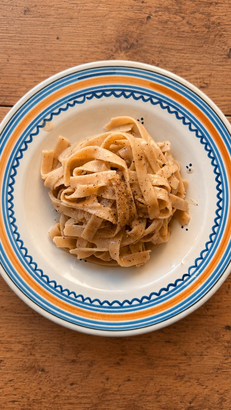 Cacio e pepe: three ingredients, endless opinions.
🤌🏼 This dish is Rome at its best: simple, stubborn, and impossible to improve when done properly.
Our founder Giulia reflects on the Roman classic that proves simplicity was never the same as being basic.
From @izziemcox
Full recipe:
Serves: 2
Time: 5 minutes
What you’ll need:
* ½ tbsp whole black peppercorns
* 250g lentil tagliatelle
* 100g pecorino, finely grated, plus extra to serve
* salt
👉🏼 Use a spice grinder or mortar and pestle to grind the pepper to a medium coarse consistency.
👉🏼 Fill a pot about halfway up with water (use a lot less than you usually would to cook pasta as you want the water to be super starchy) and salt generously. Add the tagliatelle and cook for 2 minutes.
👉🏼 Meanwhile, heat a frying pan on a medium heat and add most of the pepper, toast for one minute until fragrant.
👉🏼 Add a ladle of pasta water to the pan, use tongs to transfer the pasta to the pan and continue cooking and moving around with the tongs. Add more pasta water as needed.
👉🏼 Meanwhile, add a small amount of the pasta water to the grated pecorino to form a paste.
👉🏼 Once the pasta is cooked, remove from the heat. Wait 30 seconds then stir through the pecorino paste until creamy.
👉🏼 Plate up and finish with more pepper and pecorino.