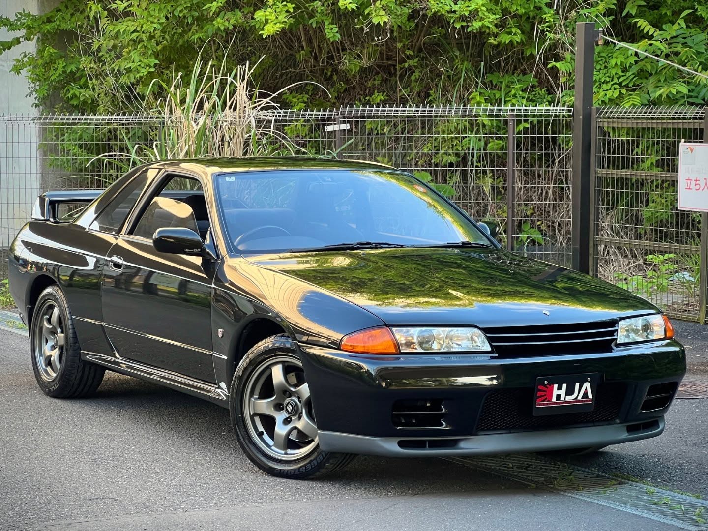 It's been a long time since we've found an R32 GT-R worthy of importing, but then this one appeared.
A beautifully preserved 1994 Nissan Skyline R32 GT-R in Black Pearl Metallic, now secured by HJA and currently on its way from Japan 🇯🇵➡️🇬🇧
This is one of those rare examples where the condition speaks for itself. Unmodified, exceptionally well cared for, and a true testament to what makes the R32 such an icon.
Cars like this are becoming increasingly difficult to find, especially in this level of preservation.
We can't wait to get it landed, detailed, and ready for its next chapter.
It still retains its original factory paint, the interior is immaculate, and the underside is clean, solid and rust free. Combined with the service history from 3rd July 1997 through to 1st July 2025, it is clear this car has been maintained and looked after to a very high standard. In many areas, it presents better than R32 GT-Rs we have inspected with far lower mileage.
It has covered 159,962km / approx. 99,395 miles, but the overall condition, originality and history are what make this example stand out.
This is a car that has clearly lived a very well-cared-for life in Japan.
The car has no accident history and comes complete with its manual, spare tyre and supporting documentation.
Secure now with a 10% deposit until ready for collection.
Additional Equipment & History
• Full service history from 03/07/1997 to 01/07/2025 dealer and specialist maintenance records.
The R32 Skyline GT-R remains one of the most iconic Japanese performance cars ever built, and this example stands out because of how well it has survived.
Original paint, an immaculate interior, a rust-free underside and almost three decades of recorded maintenance history make this a very honest and properly cared-for R32 GT-R.
Apart from the upgraded performance suspension dampers, the car remains mechanically stock factory specification, which is increasingly difficult to find with R32 GT-Rs today.
Before handover, the car will receive a full service and health check, including a genuine Nissan cambelt and water pump kit, giving the next owner added reassurance from day one.