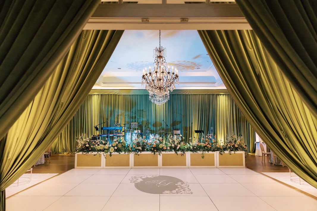 There is simply no other decor installation that adds texture, depth, and dimension to an event space the way that fabric does when it is LAYERED throughout a room.
A draped doorway that opens into a fully draped interior creates a sense of arrival, of anticipation, of pure luxury that guests feel the moment they walk in. It’s not just decoration, it’s an experience.
With decades of expertise and an extensive linen and drapery inventory, no one creates those experiences quite like Party Tables. Ready to transform your space? Connect with our team and build your dream experience from the ceiling to the tabletop >> bit.ly/PartyTables #LinkInBio
Photography: @demimabry
Planning & Design: @sohoeventdesign
Venue: @quailhollowcountryclub
Florals: @floressenceflowers
Draping: @partytables_linensandrapery
Speciality rentals: @marthamydearrentals
Custom barback shelves: @oxumeventdesign
Linens: @bbjlatavola
Lighting: @illuminationclt
Dance floor decal: @heritagedesigns
Stationery: @virilovelydesigns
Custom welcome wall: @knottyartisans
Ceremony music: @deansduets
Cocktail hour music: @darrellhootsmusic
Band: @lovestruckparty
Live guest painter: @meliyaloosleart
Cake: @mariannetayloecake
Custom ice cubes: @artisanicesculptures
Cold sparks: @splitsecondsound
Getaway car: @carolinaclassiccarrentals
Beauty: @jenniferabercrombiebeauty
Wedding gown: @amsaleweddings @ladiesoflineage
Tuxedo: @brooksbrothers
Videographer: @dockhousedigital
#EventExperience #EventDesign #WeddingDesign #EventDrapery