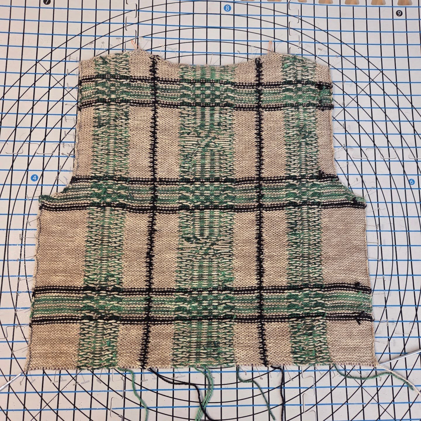Back is in blocking - and yes, this is the wrong side 😆 The grid on the fabric makes the blocking very easy to do 😃
The Moving Still vest is worked in Intarsia mixed with stranded colorwork at the green columns. This is the reason the back is worked flat to the ribbing, and blocked to measurements.
Then, the front shoulders will be picked up at the shoulders of the back and worked to form a V neck, then joined to be worked in one piece exactly as the back to the same length, and blocked flat to measurements.
The only seams needed are the side seams using simple mattress stitch (tutorials are included in the pattern for the short rows, color management and seaming).
Lastly, the ribbing of the neck, armholes and bottom hem are all worked in the round.
It's a really fun potato chippy project! Not too complicated and the only time you need to actually follow a chart is the crossing of the lines at the center. The rest is TV knitting 🤩
If you want to be a tester for this vest, you can join our circle on my website (knitofthegragon.com) and get the call when it opens 🥰
Can't wait to move forward to the front!
#knittingvest #KnitOfTheDragon #knittingdesigner #knittingpatterns #knittingcolorwork