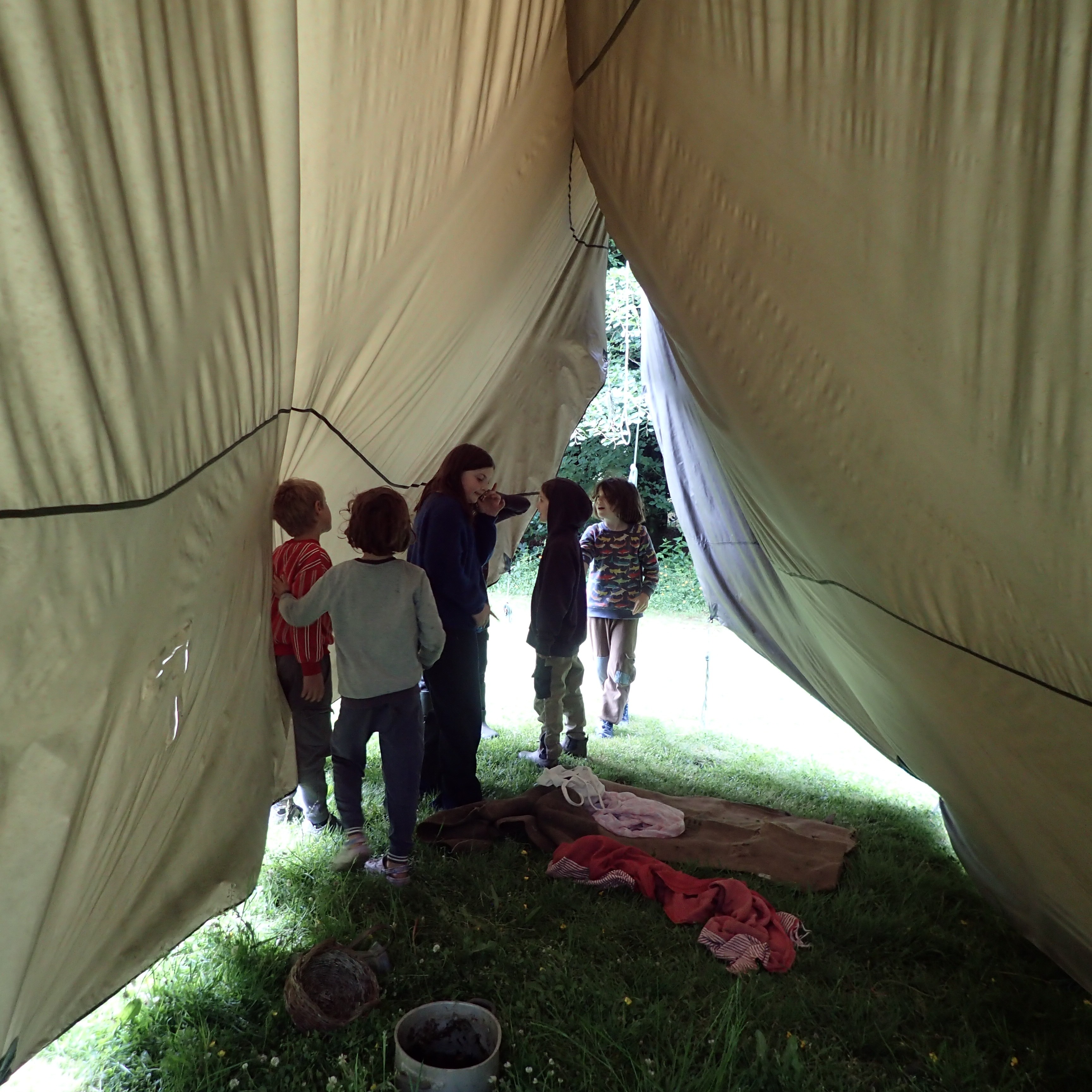 We thought we'd hung the tarp over the meadow to seal the seams. They decided it was an excellent den space :) #tarpaulin #den #forestschool