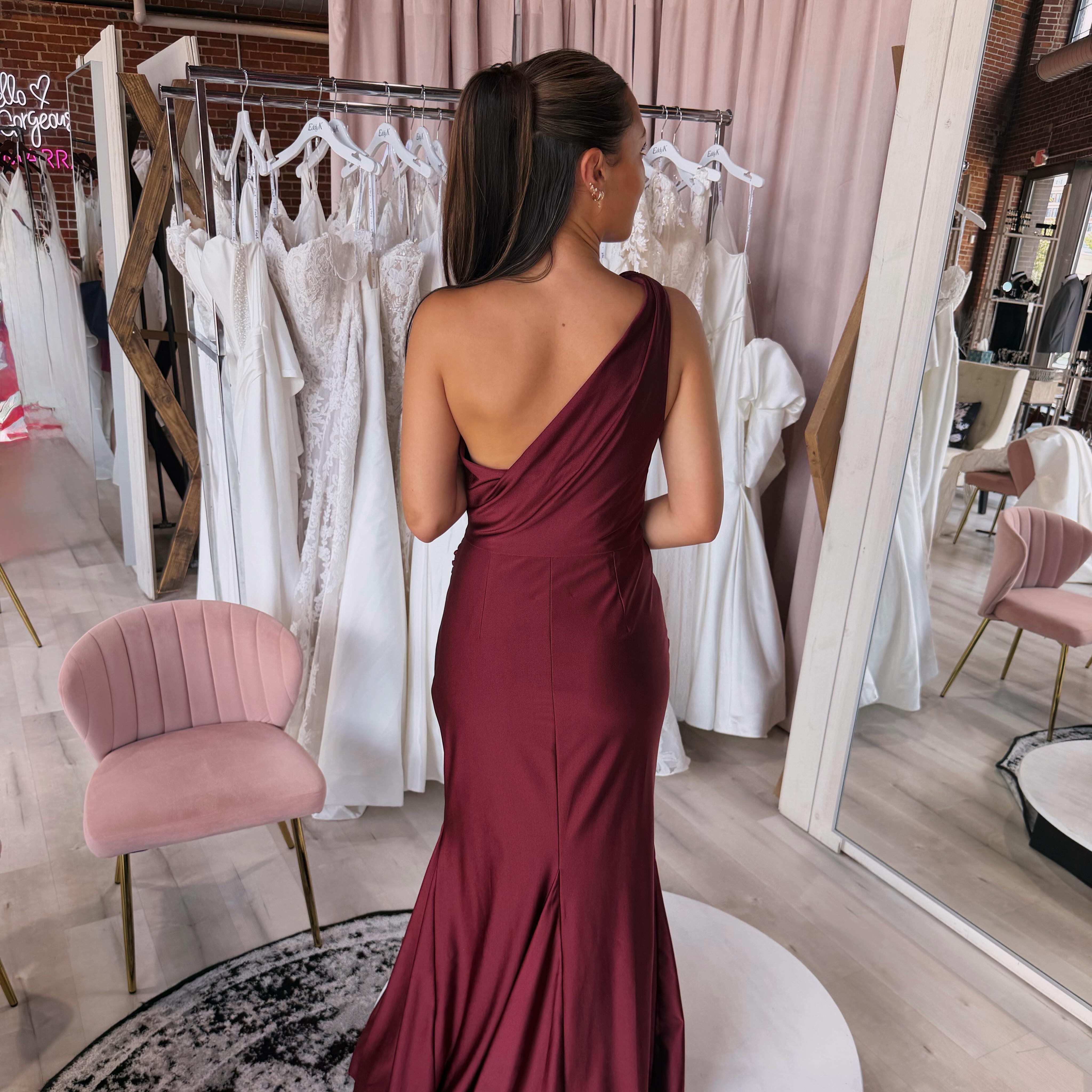 🍷 Obsessed with this burgundy satin beauty ✨ One shoulder, open back, and effortlessly elegant. ❤️ @dessygroup #bridesmaid #openbackdress #dress