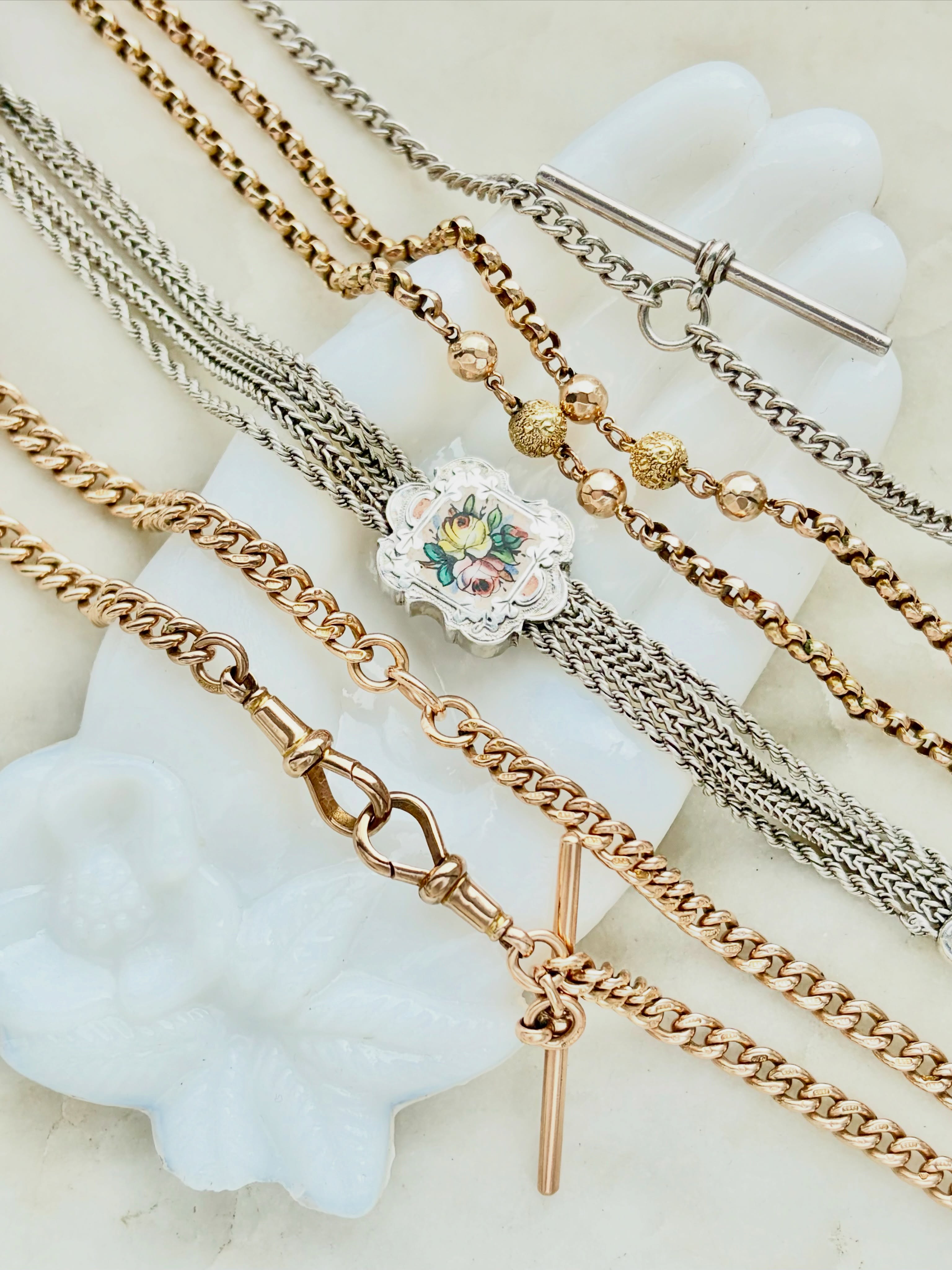 ⛓️ Our chain game is strong at the moment 💛 (Even if we do say so ourselves 😳) We have a mix of antique and vintage chains in gold and sterling silver, in a variety of lengths and styles ✨ Our favourites include the antique gold curb link double dog clip and T-bar watch chain, every curb link is hallmarked 😍 We also love the antique enamel sterling silver slider chain 🌸 It’s so rare to find these with enamel flowers like this one. We also have a mix of longer lengths too, like the 9ct gold and ball detail belcher chain. You can find them all and others too over on our website #antiquechain #vintagechain #watchchain #curbchain #dogclipchain